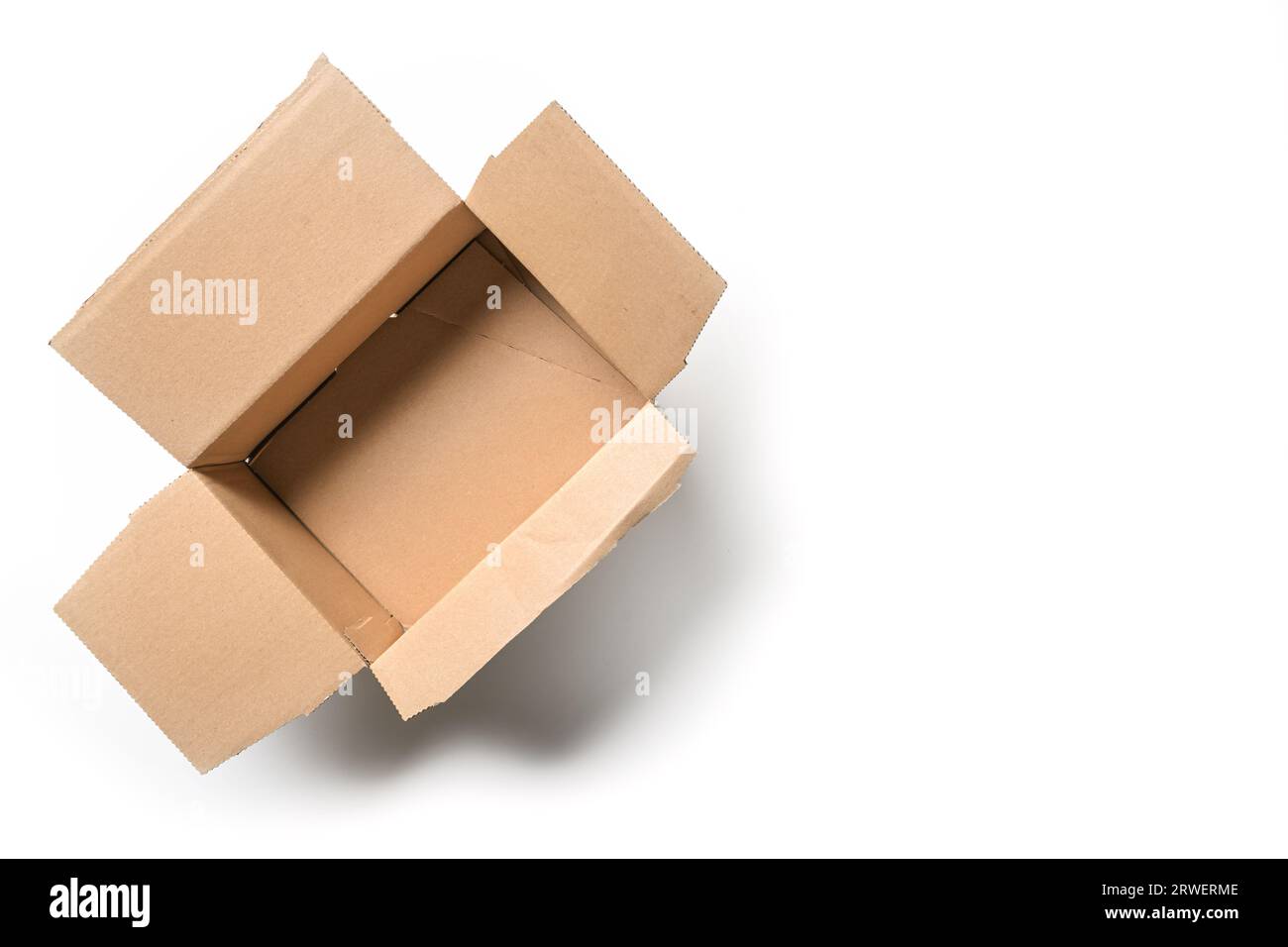 Open empty cardbord box package for delivering and transport on a white background, high angel view from above, copy space, selected focus Stock Photo