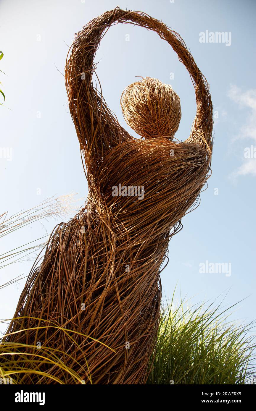 Dancing or whirling person made of straw conveys passion for dancing. Fictional woman executing a sufi whirling or sufi turning against a blue sky Stock Photo