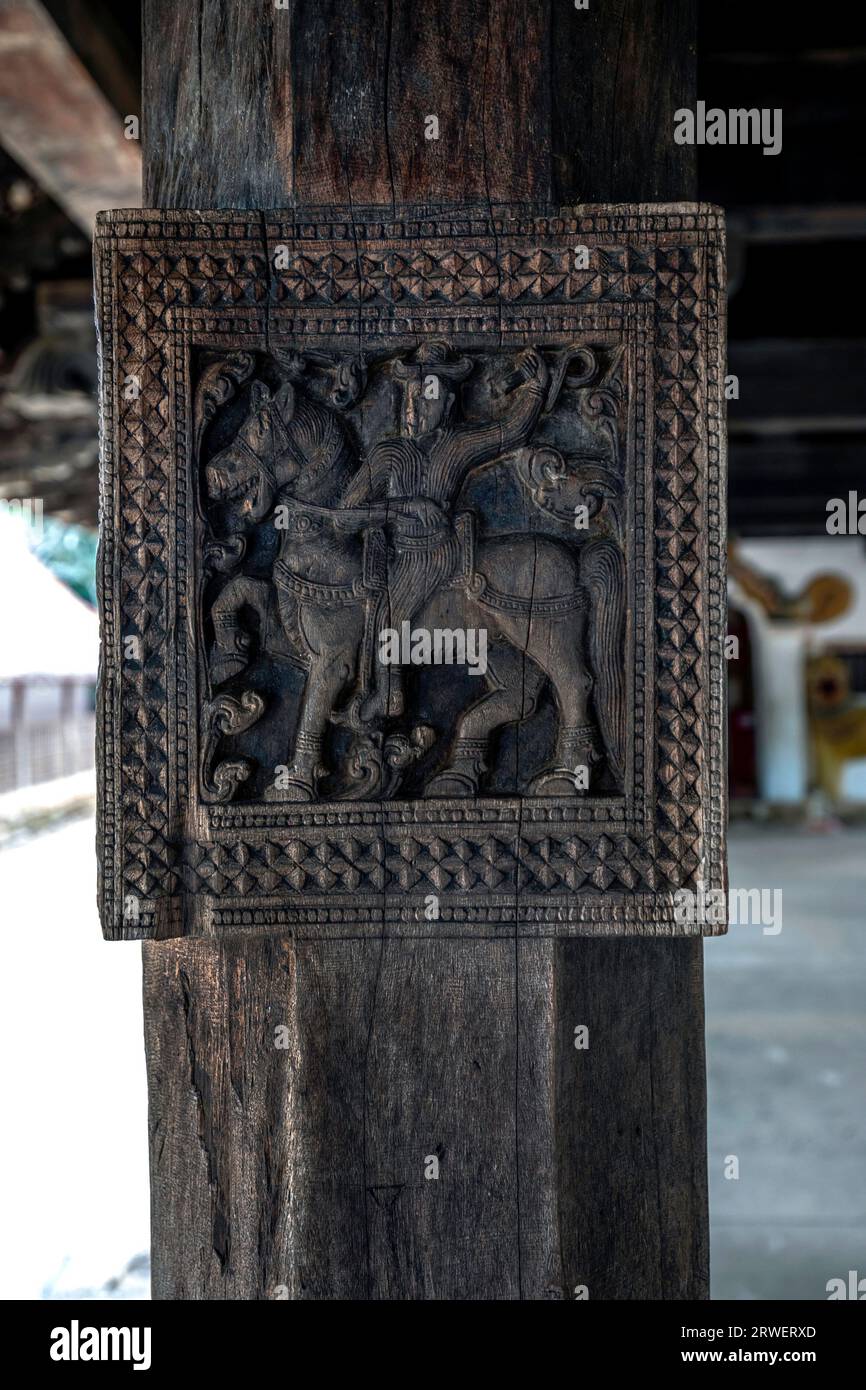 An ancient carving depicting a man riding a horse located on one of the wooden pillars in the digge (drummers pavilion) at Embekke Devale in Sri Lanka Stock Photo