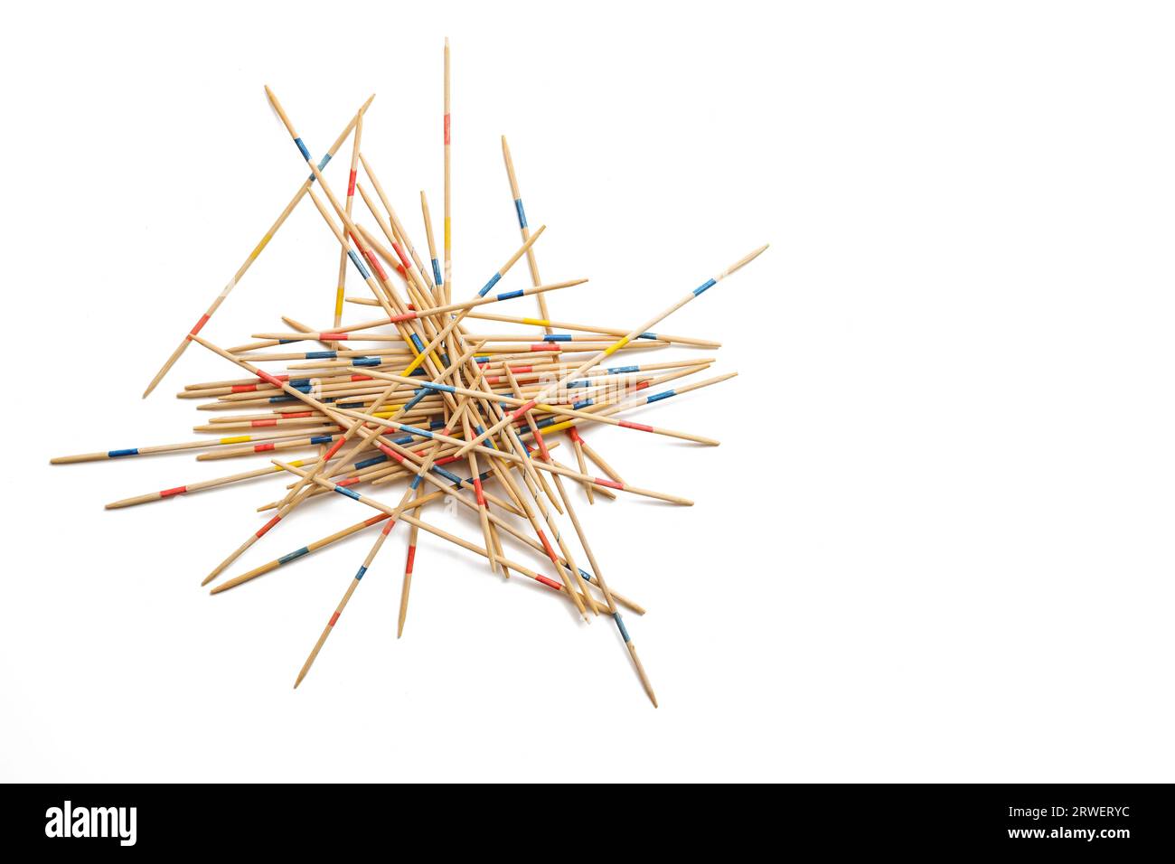 Mikado game on white, wooden pick-up sticks should be taken without moving the others, metaphor in business to solve one problem after another without Stock Photo