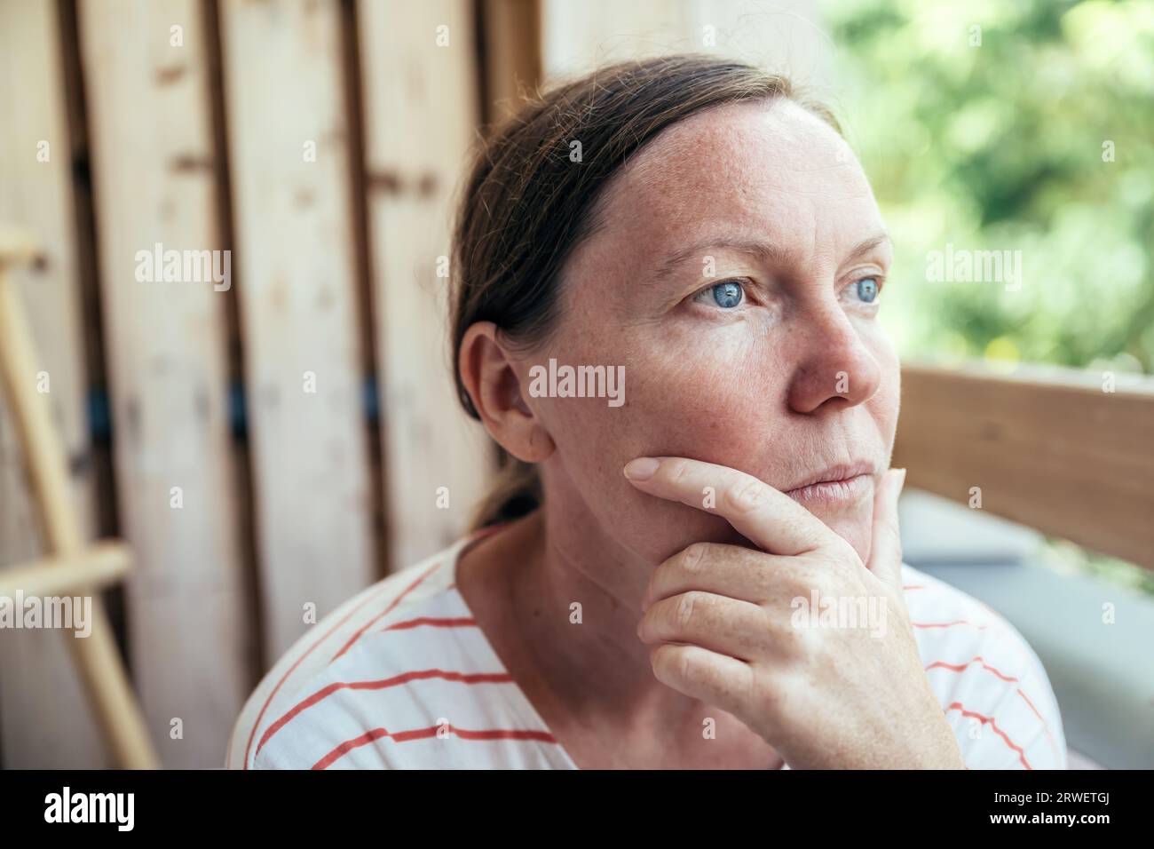 Contemplative adult female thinking and looking into distance in summer morning, selective focus Stock Photo