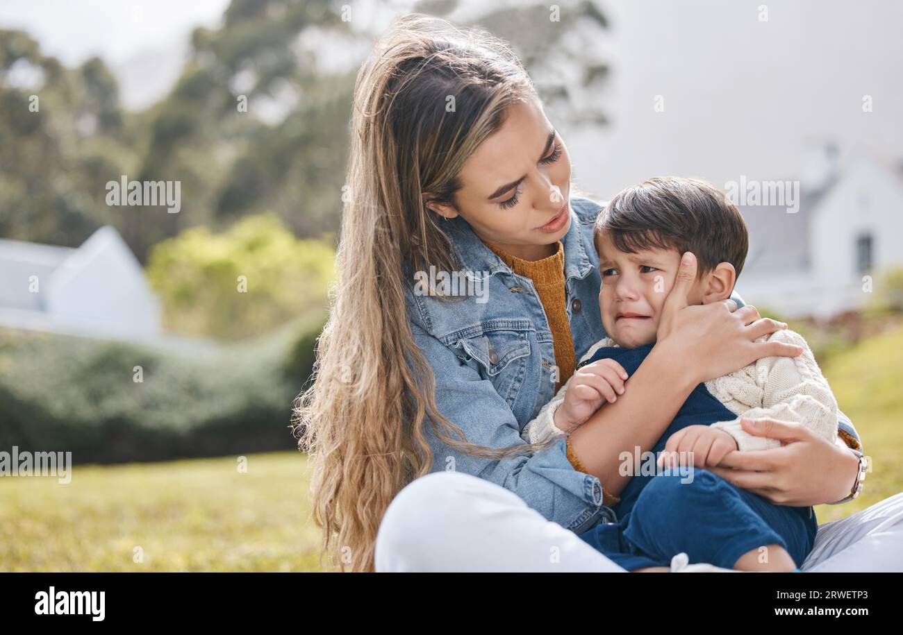 Outdoor, mother and kid crying, sad and comfort with pain, injury and ...