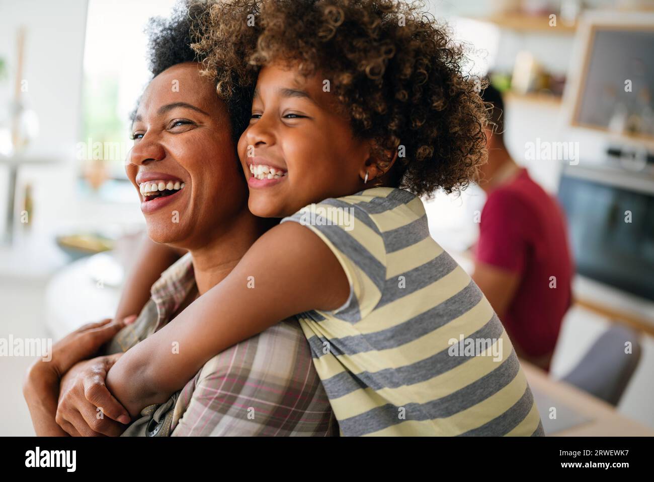 African american woman hugging her smiling teen daughter. Family love single parent child concept Stock Photo