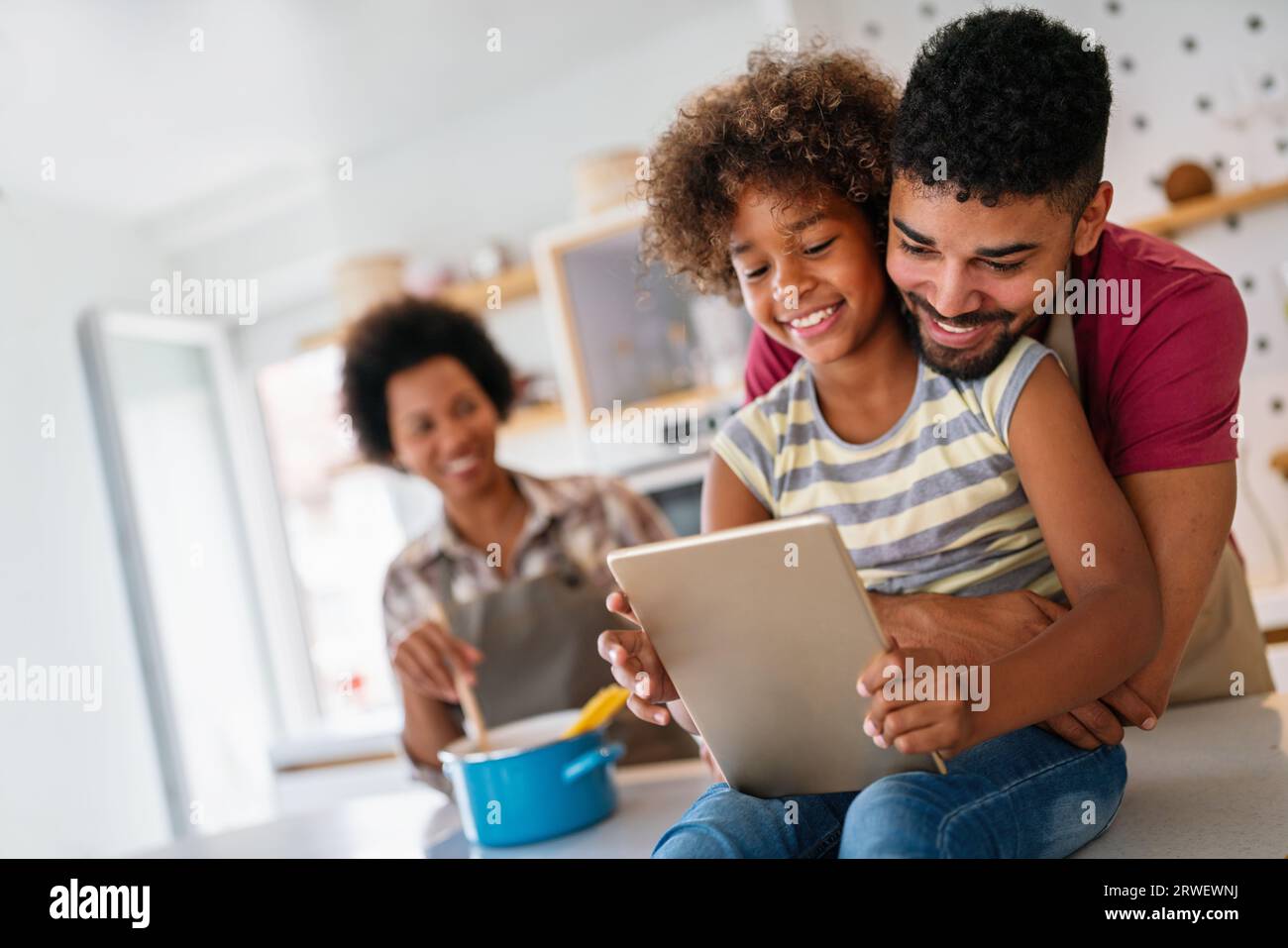 African family tablet and child learning at home with happiness, development, internet connection. Stock Photo