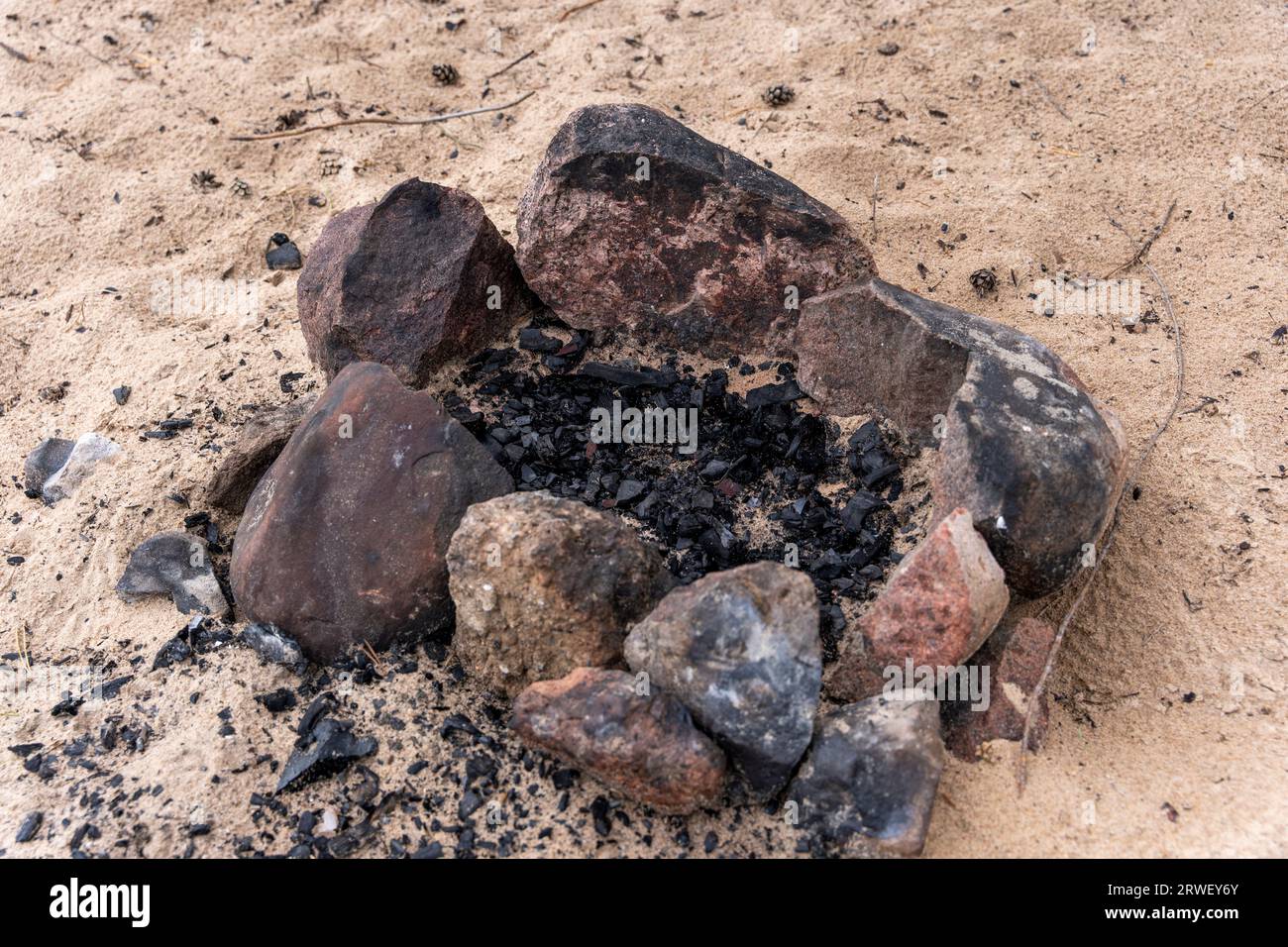 an extinct bonfire of stones on the beach. An extinct campfire. High ...