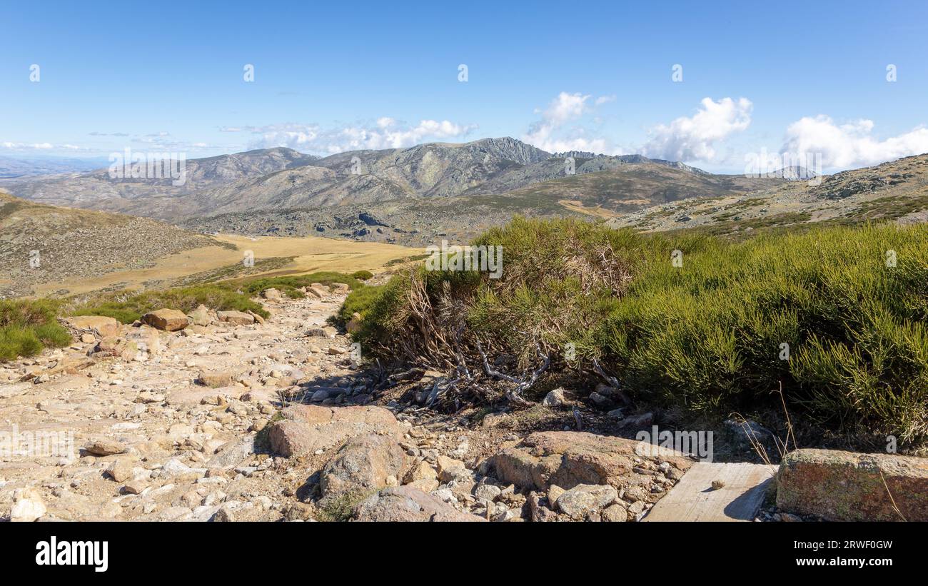 Sierra de Gredos mountains landscape in autumn, dirt rocky trail to the Laguna Grande de Gredos lake from the Plataforma de Gredos in Sierra de Gredos Stock Photo