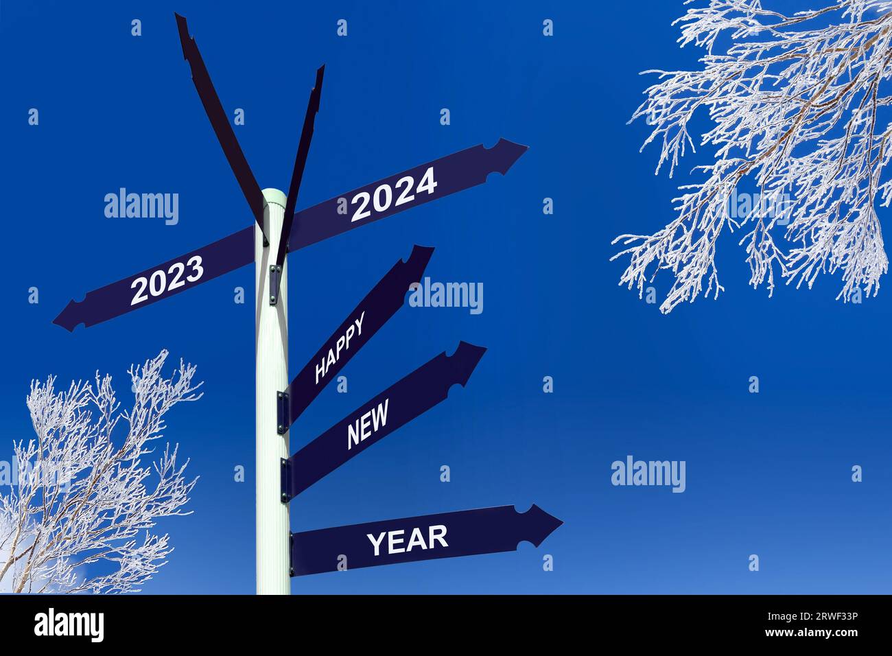 Happy new year 2024 on direction signs, snowy frosty trees and blue sky , winter greetings Stock Photo