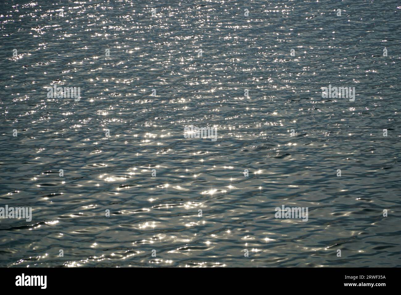 Sun reflecting in water surface Stock Photo - Alamy