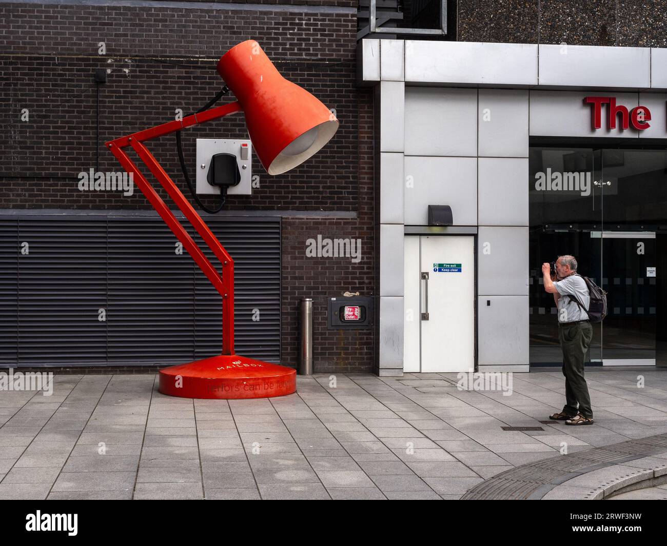 Artwork in the form of a giant red desk lamp at the entrance to the The ...