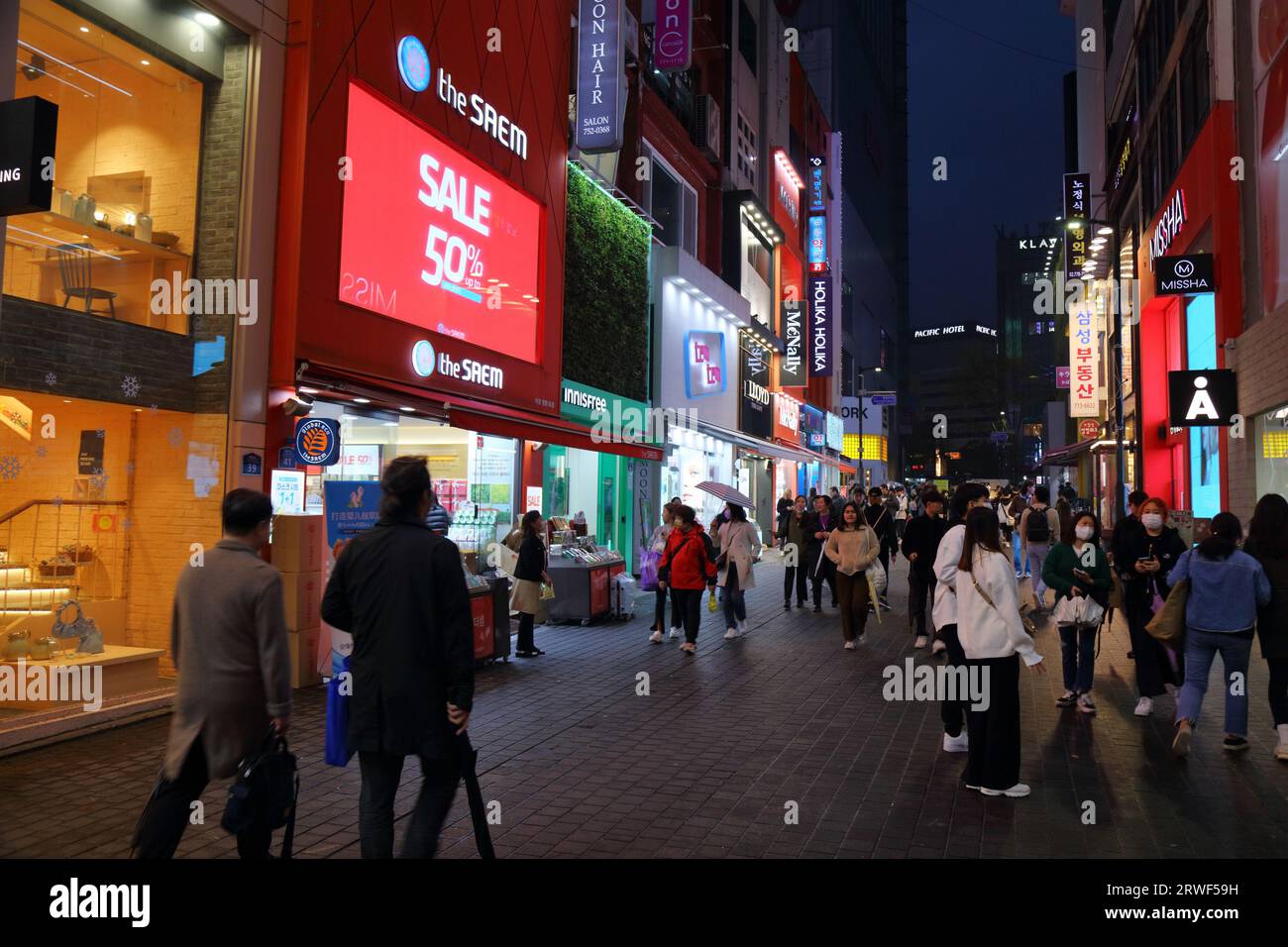 SEOUL, SOUTH KOREA - APRIL 5, 2023: People visit Myeongdong shopping district in Seoul by night. Stock Photo