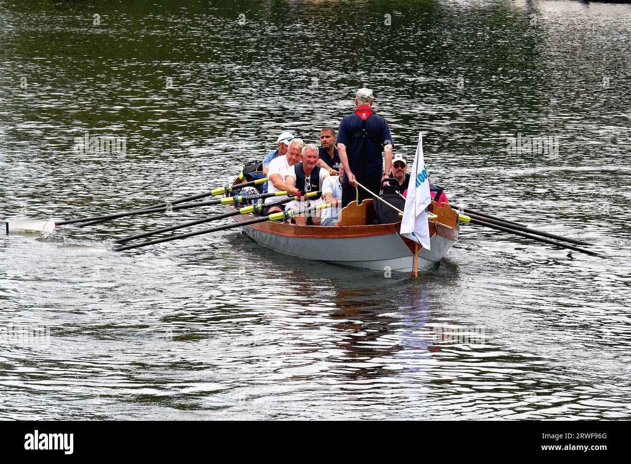 A group of middle rowers rowing boat on the River Thames at Shepperton