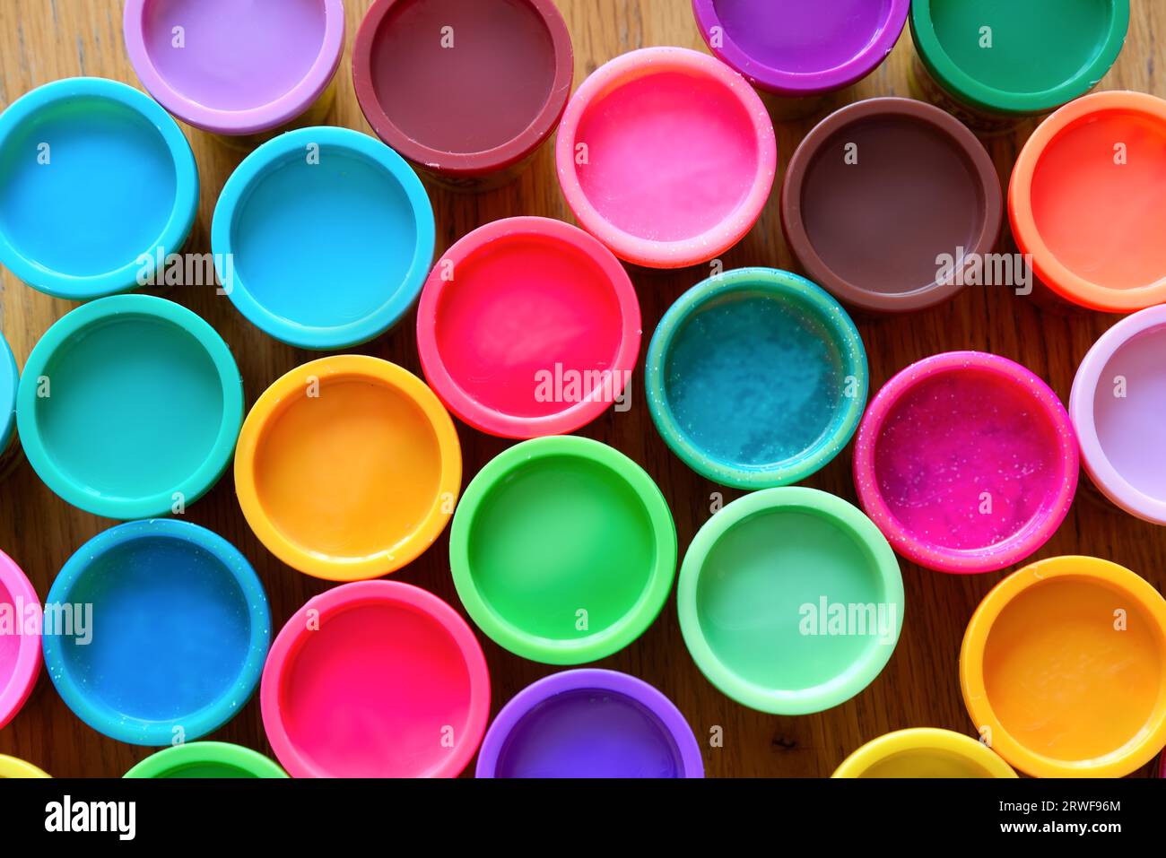 A colourful circular pattern created by multi coloured plastic tops arranged into an abstract image Stock Photo