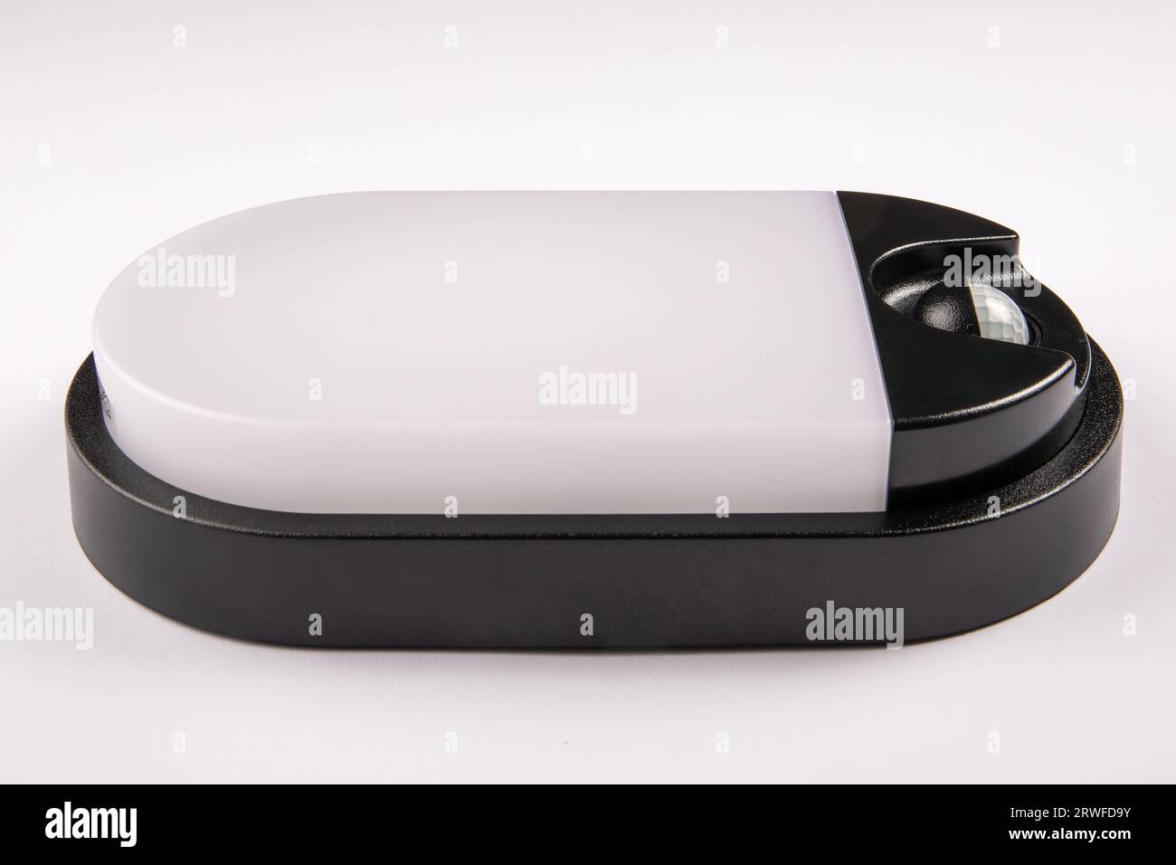 Led lamp with a motion sensor on a white background. Close up. Stock Photo