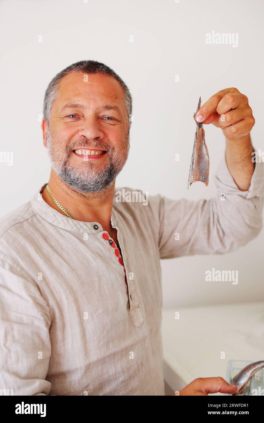 Man eating the dutch soused herring isolated background Stock Photo Alamy