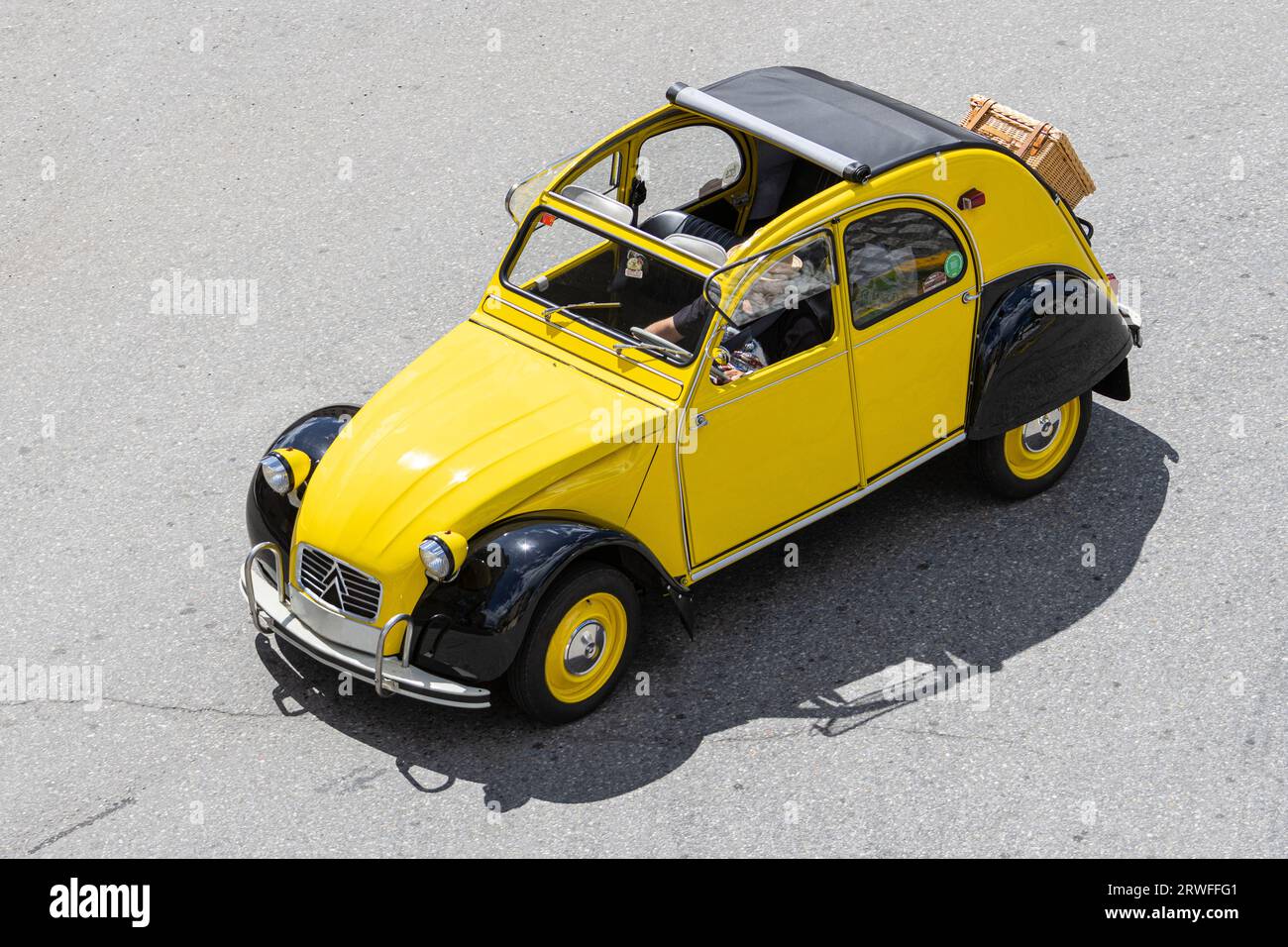 Galicia, Spain; august 27, 2023: High angle view of a Citroen 2CV classic car driving on a road Stock Photo