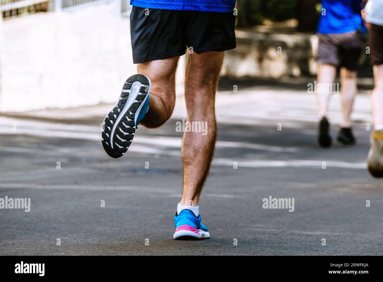 close-up sole of running shoe male runner, summer marathon race Stock Photo