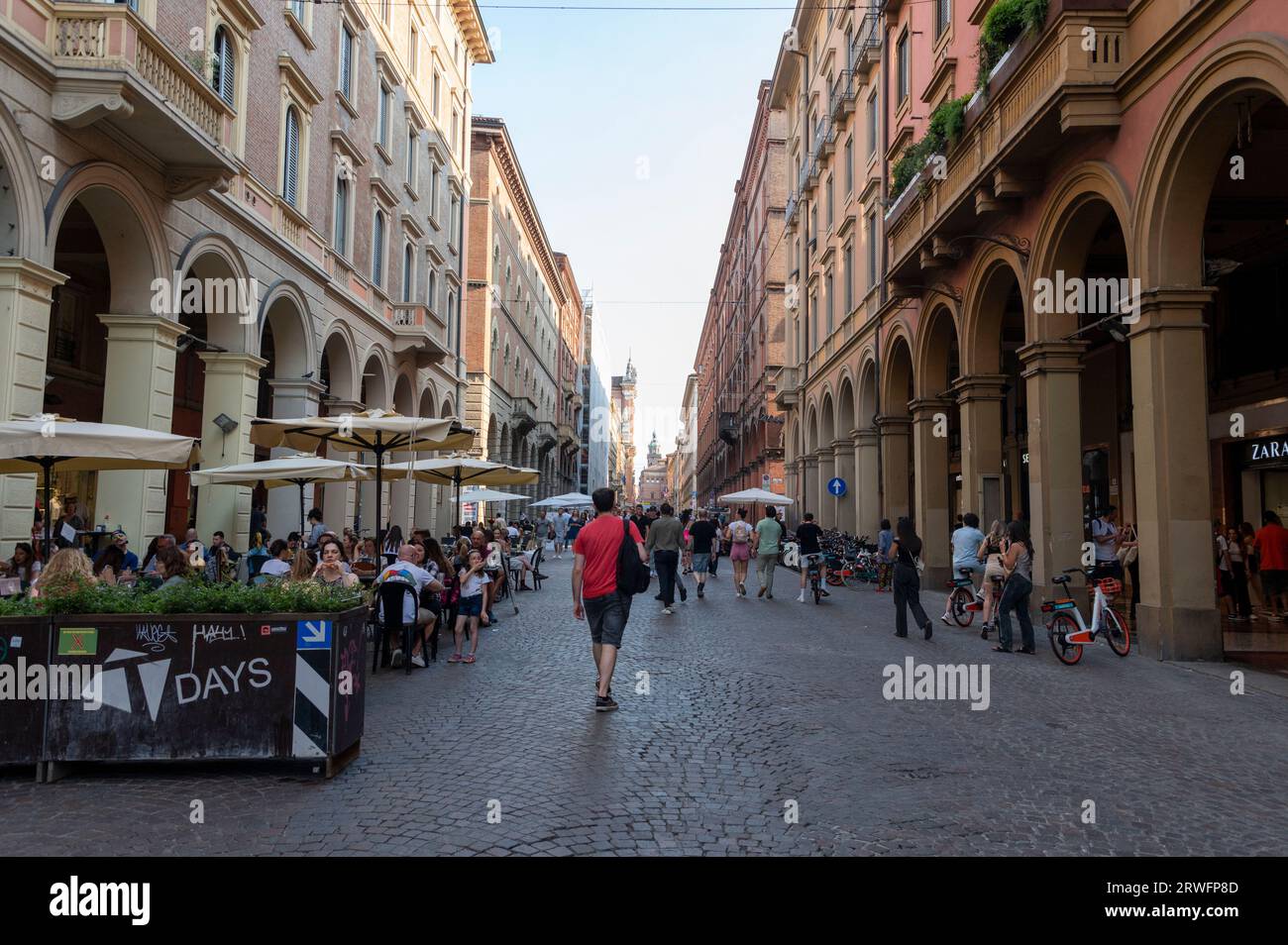 Diners and shoppers are able to enjoy shopping on Via dell'Indipendenza in safety as the one kilometre long straight Avenue is closed to traffic on we Stock Photo
