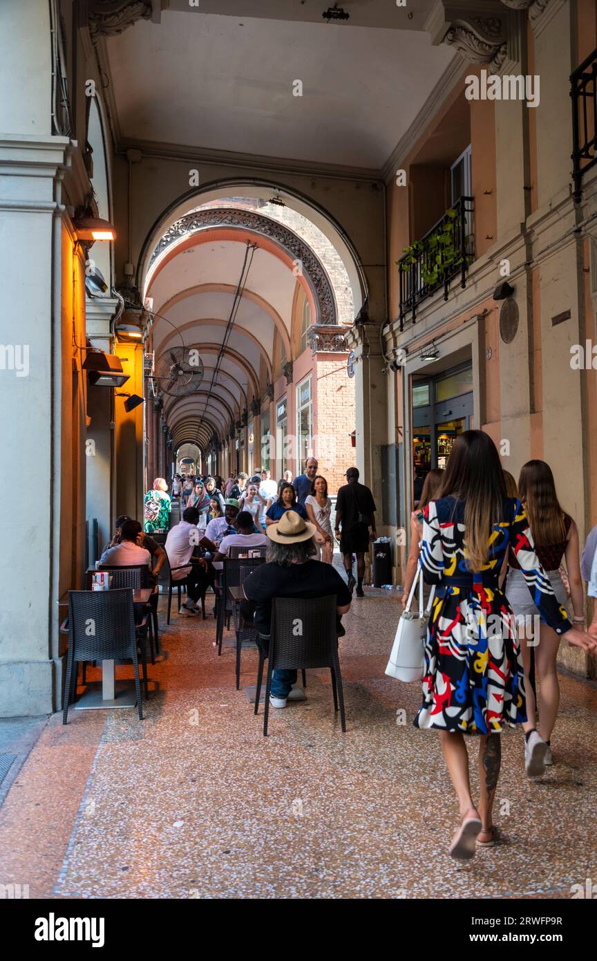 Diners and shoppers are able to enjoy and share the same covered long high ceiling portico or colonnades with a roof structure over a walkway supporte Stock Photo