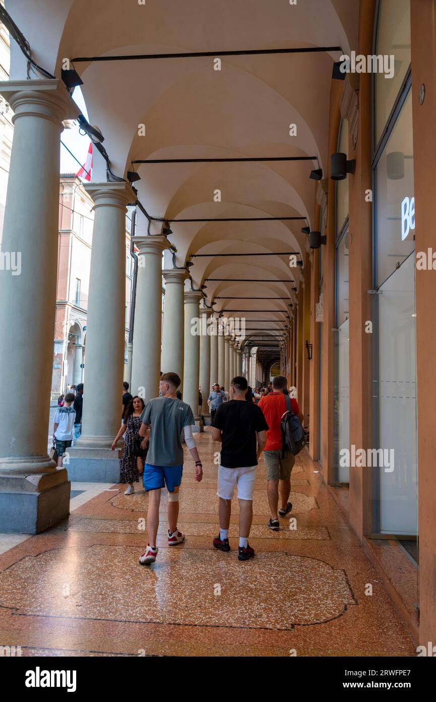 Shoppers are able to enjoy shopping under the covered long high ceiling portico or colonnades with a roof structure over a walkway supported with larg Stock Photo