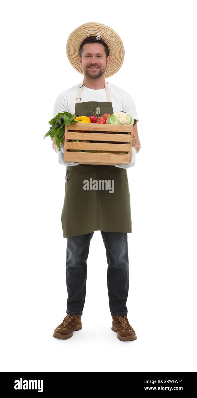 Harvesting season. Happy farmer holding wooden crate with vegetables on ...