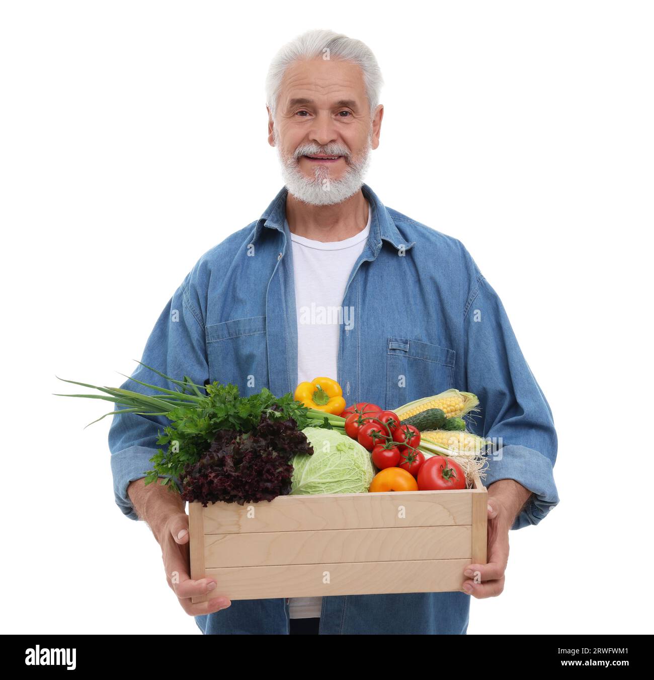 Harvesting season. Happy farmer holding wooden crate with vegetables on ...