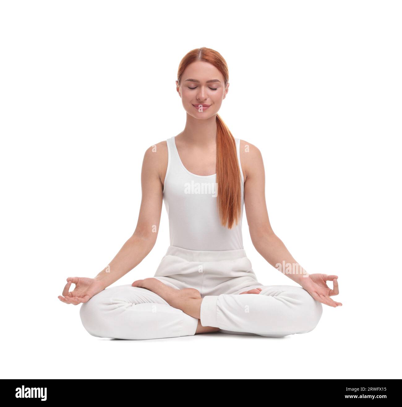 Beautiful young woman practicing yoga on white background. Lotus pose ...
