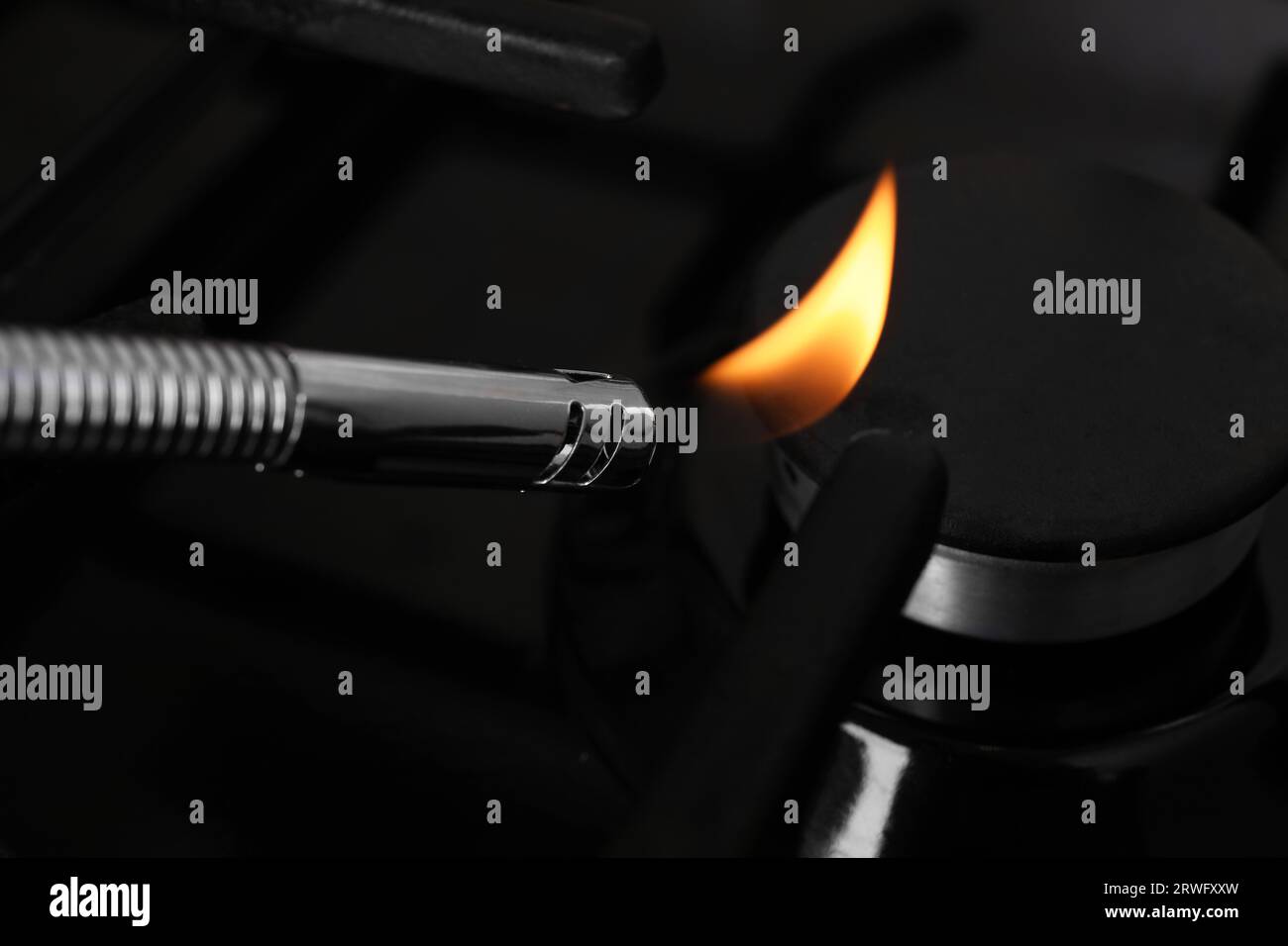 Lighting stove with gas lighter, closeup view Stock Photo Alamy