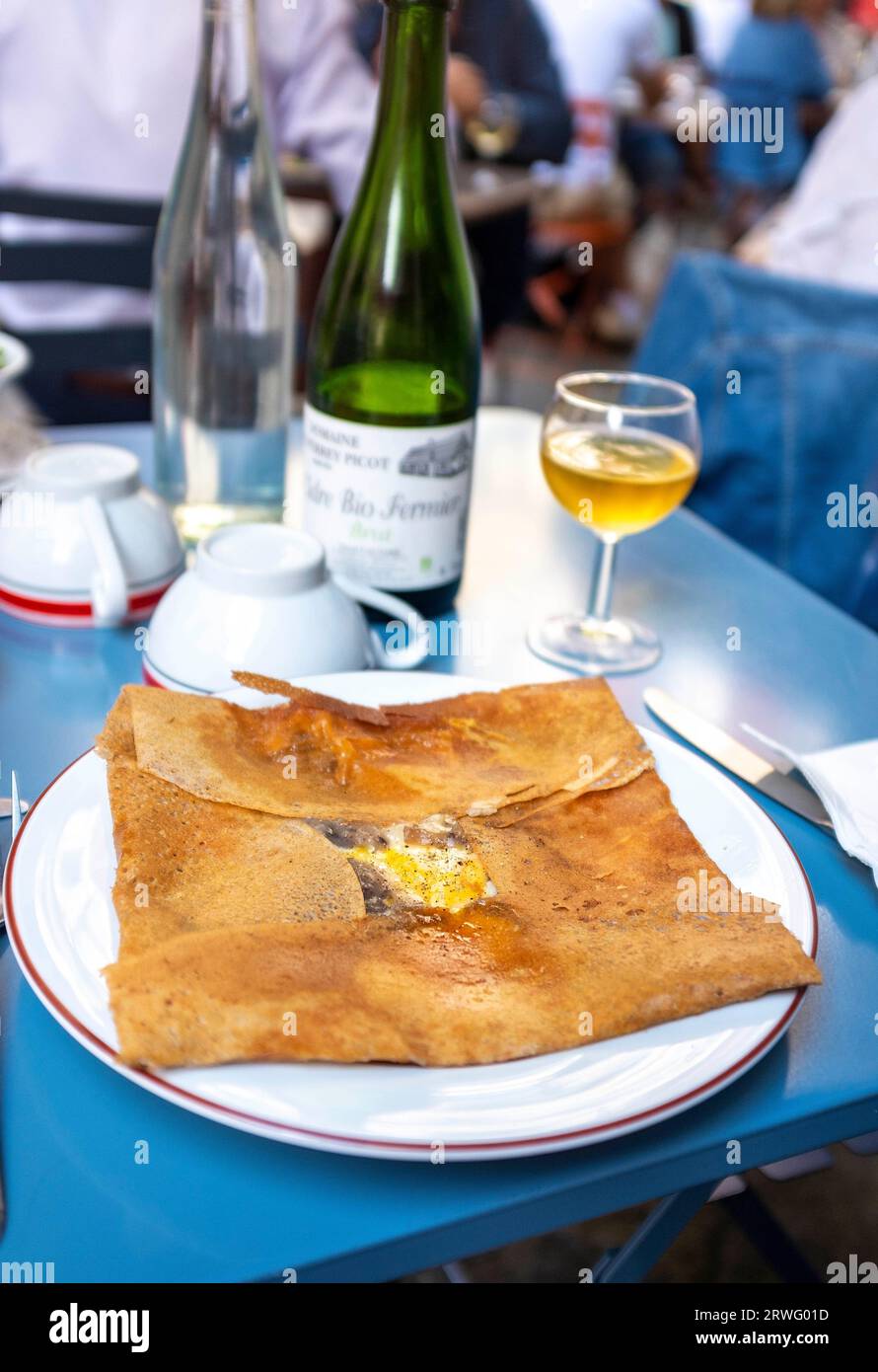 Rouen Normandy France - A typical Normandy savoury ham cheese and egg galette served with cider at one of the many street restaurants Stock Photo