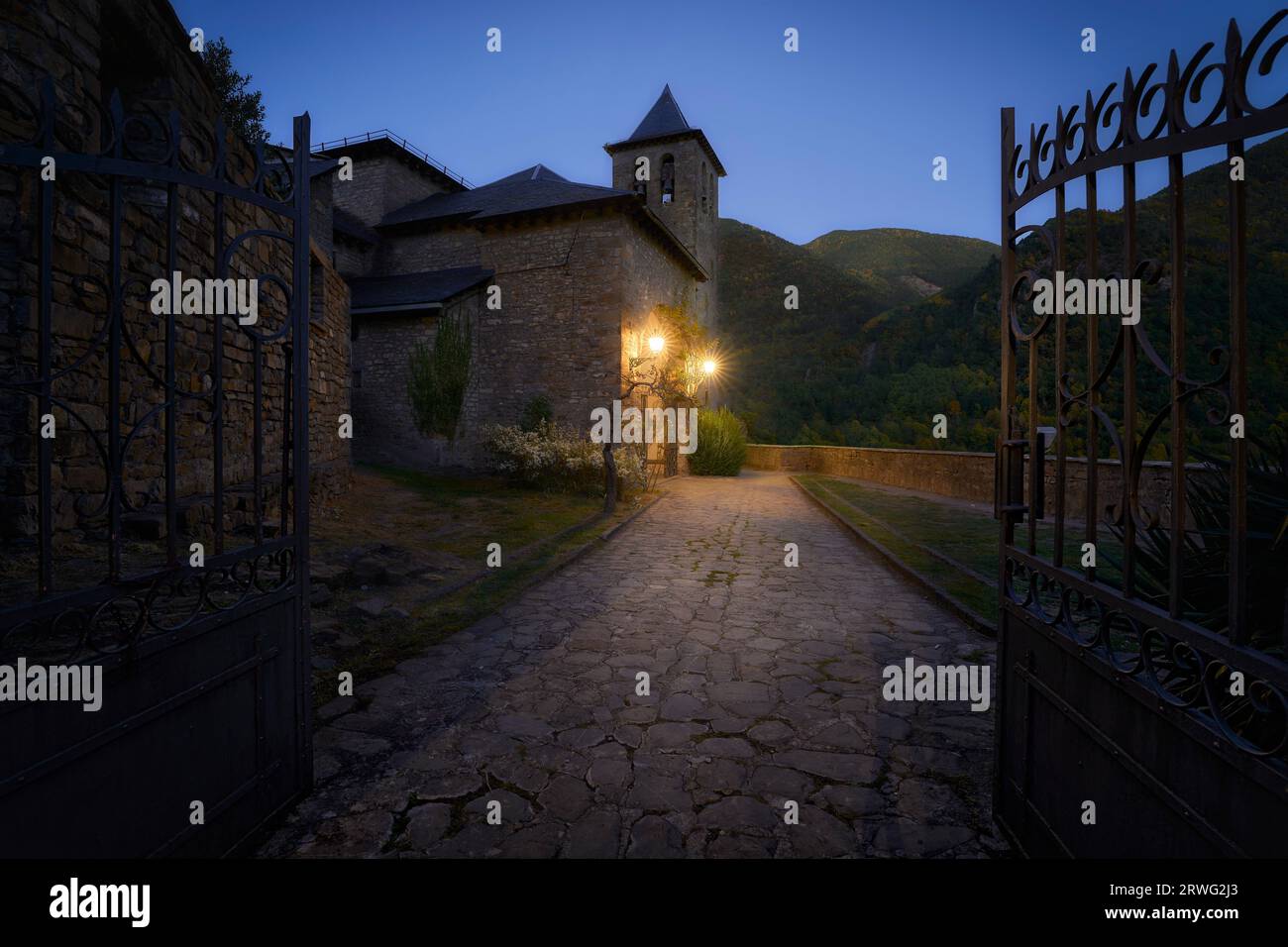 San Salvador church in Torla-Ordesa during the blue hour with an atmosphere of mistery Stock Photo
