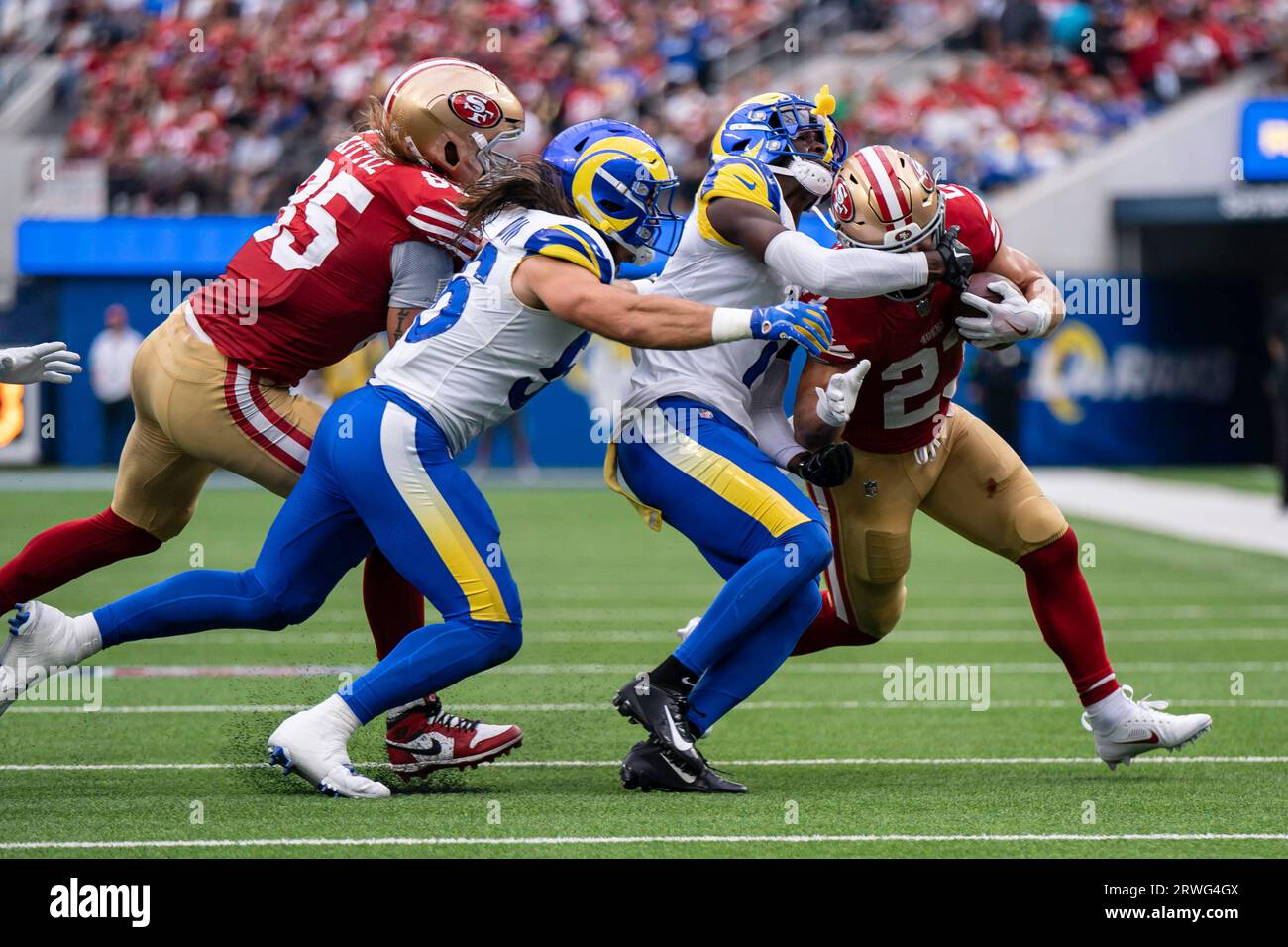 San Francisco 49ers running back Christian McCaffrey (23) is wrapped up