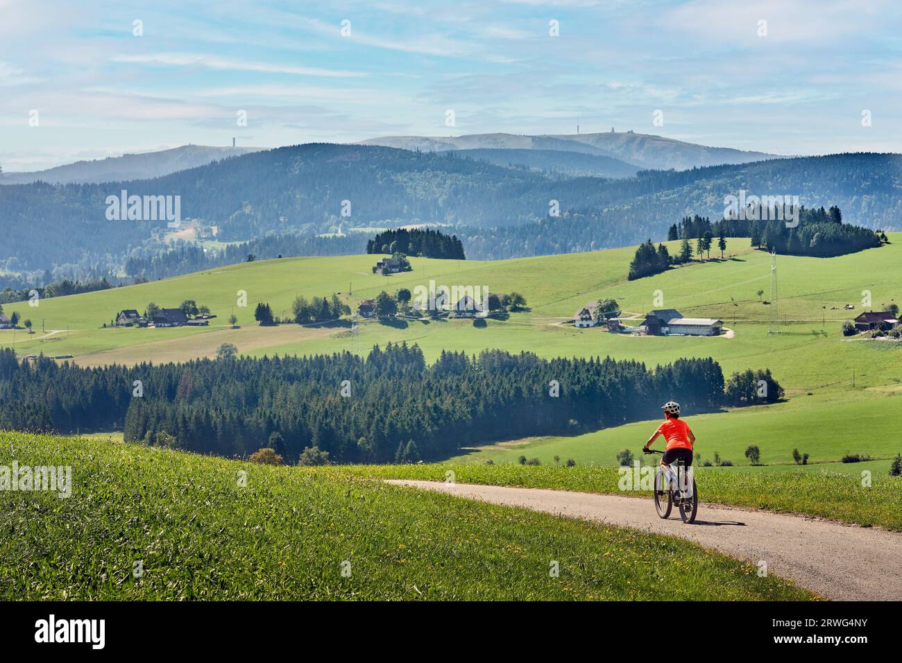 nice senior woman on her electric mountain bike cycling in the German Black Forest near Titisee-Neustadt, Baden-Württemberg, Germany Stock Photo