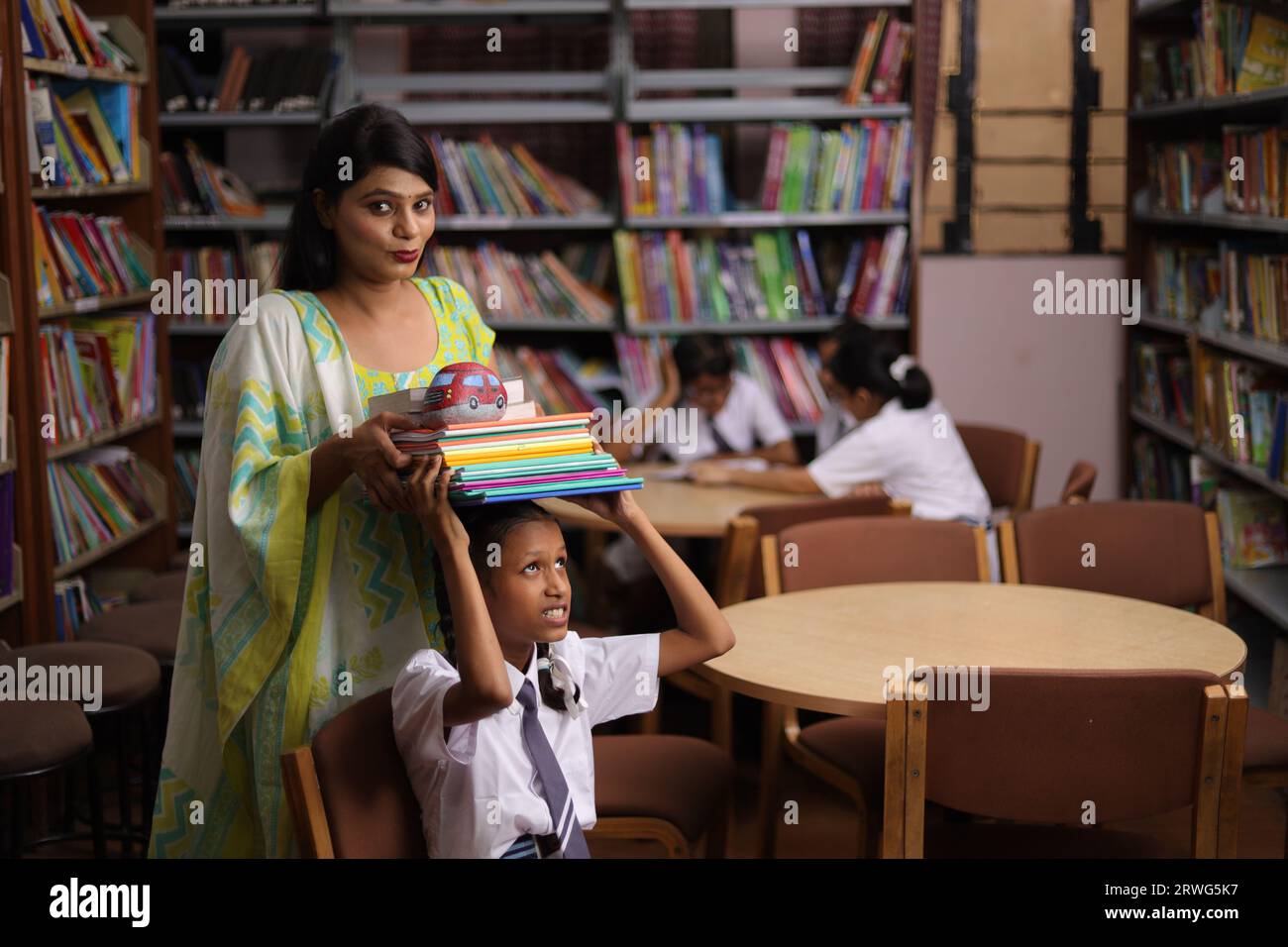 Library teacher giving books children hi-res stock photography and images -  Alamy