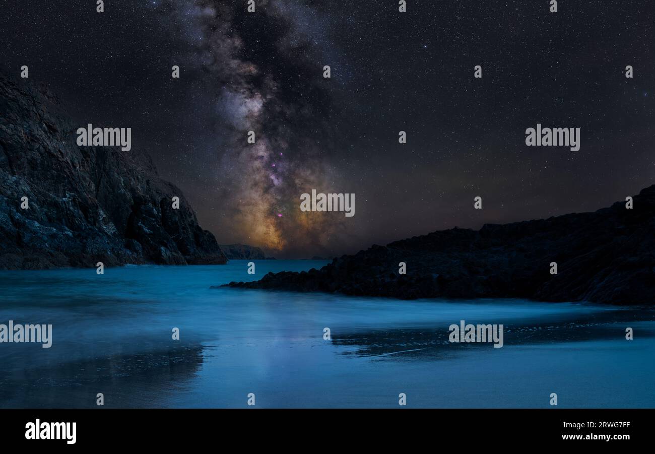 The Milky Way and it's core over Kynance Cove on the Lizard peninsula, Cornwall Stock Photo