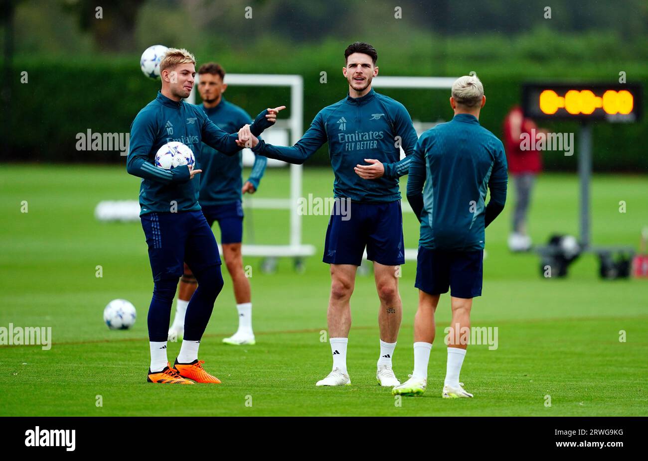 Arsenal's Declan Rice (centre) with Emile Smith Rowe and Leandro Trossard (right) during a training session at the Arsenal Training Centre, London. Picture date: Tuesday September 19, 2023. Stock Photo