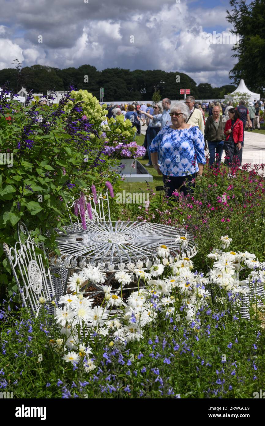 Visitors & trade stands (people view showground exhibitor's display, patio furniture seating