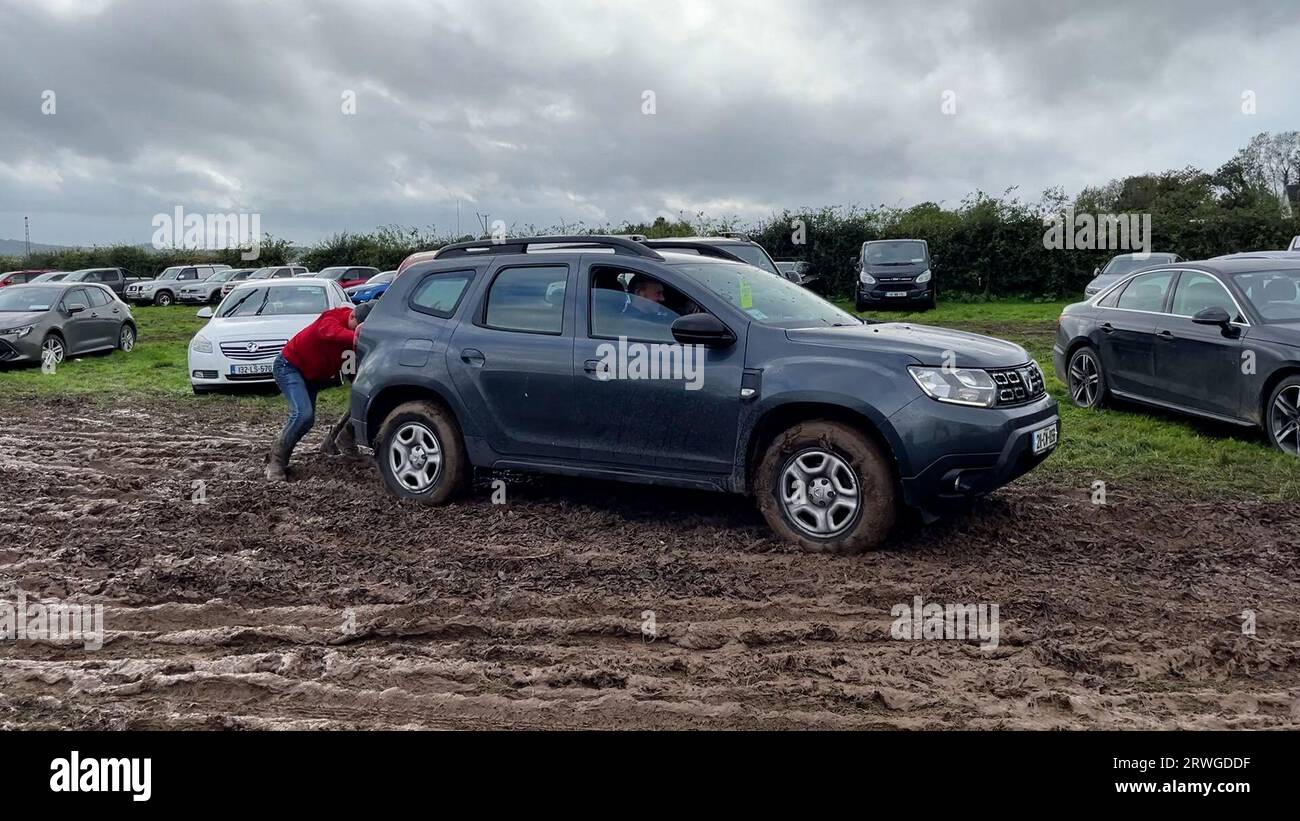 Stuck cars being pushed out of the mud at the Ploughing Championships
