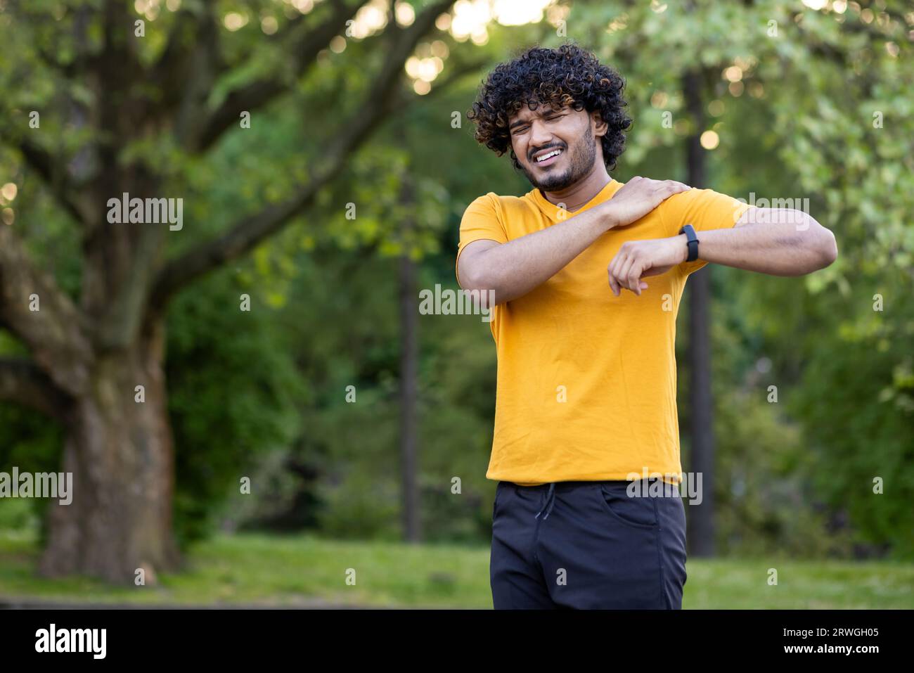 Indian young man doing morning jogging and resistance exercises. Pulled