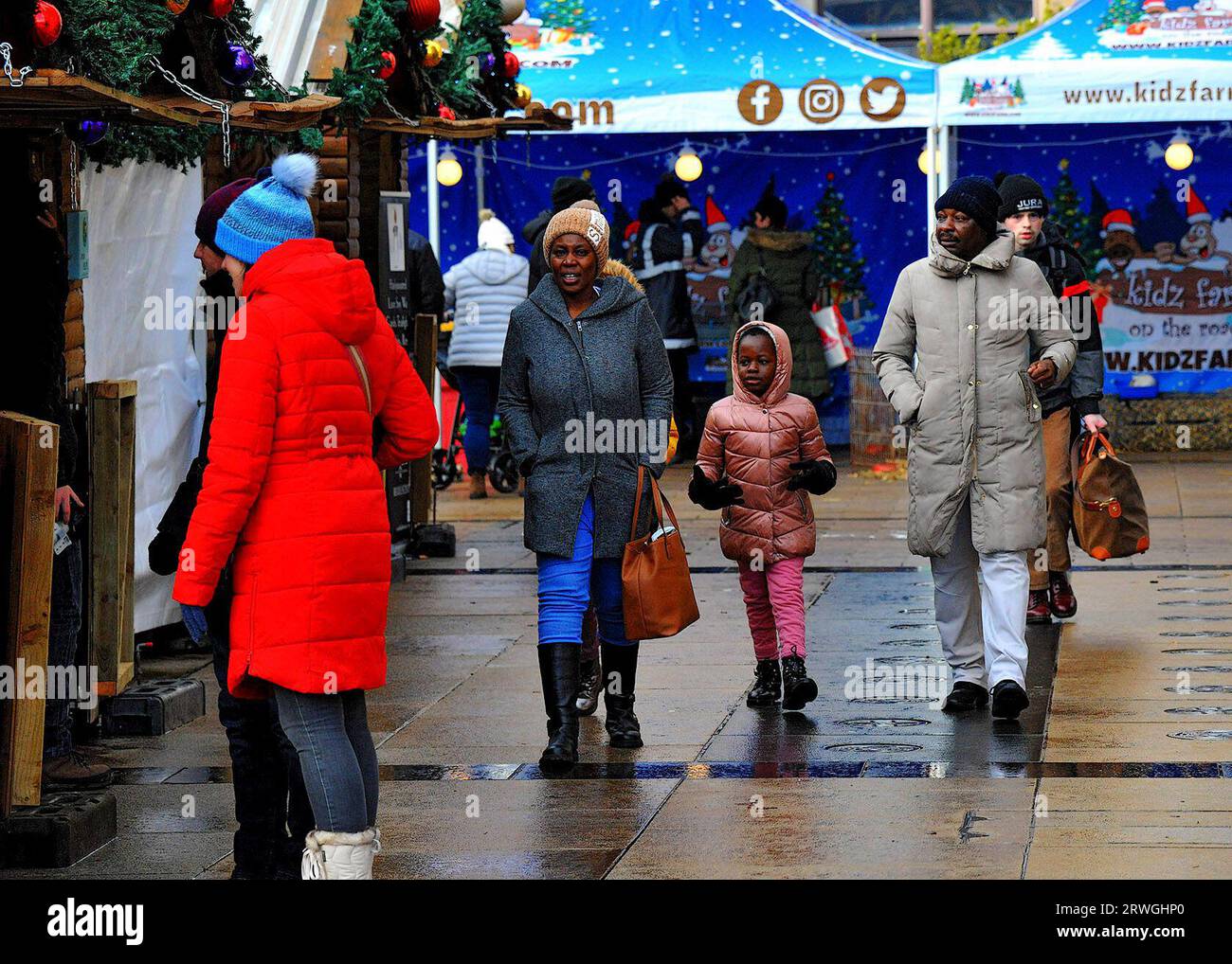 People visiting the Christmas Market in Guildhall Square, Derry