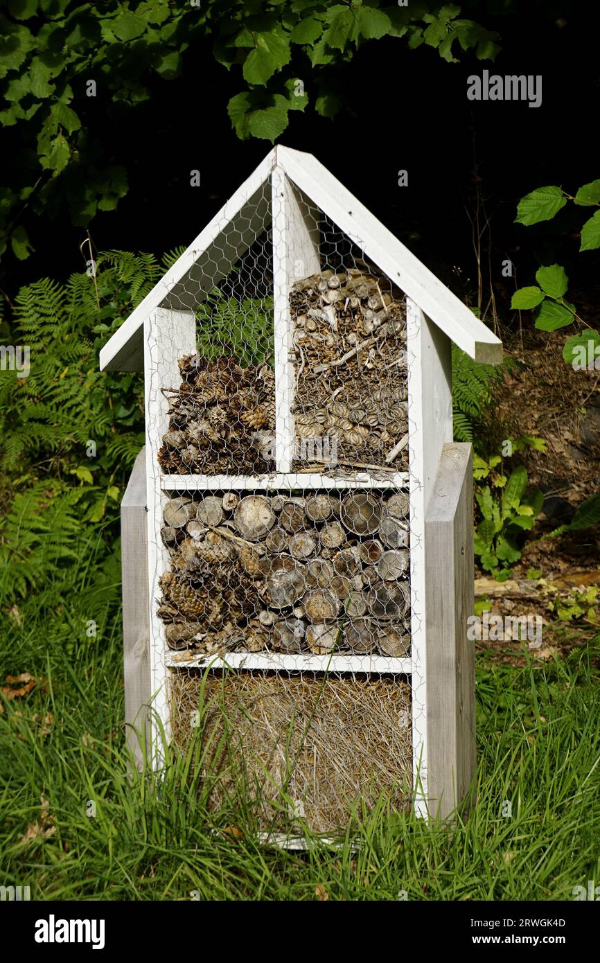 Insect hotel. Wooden structure filled with natural material ready to ...