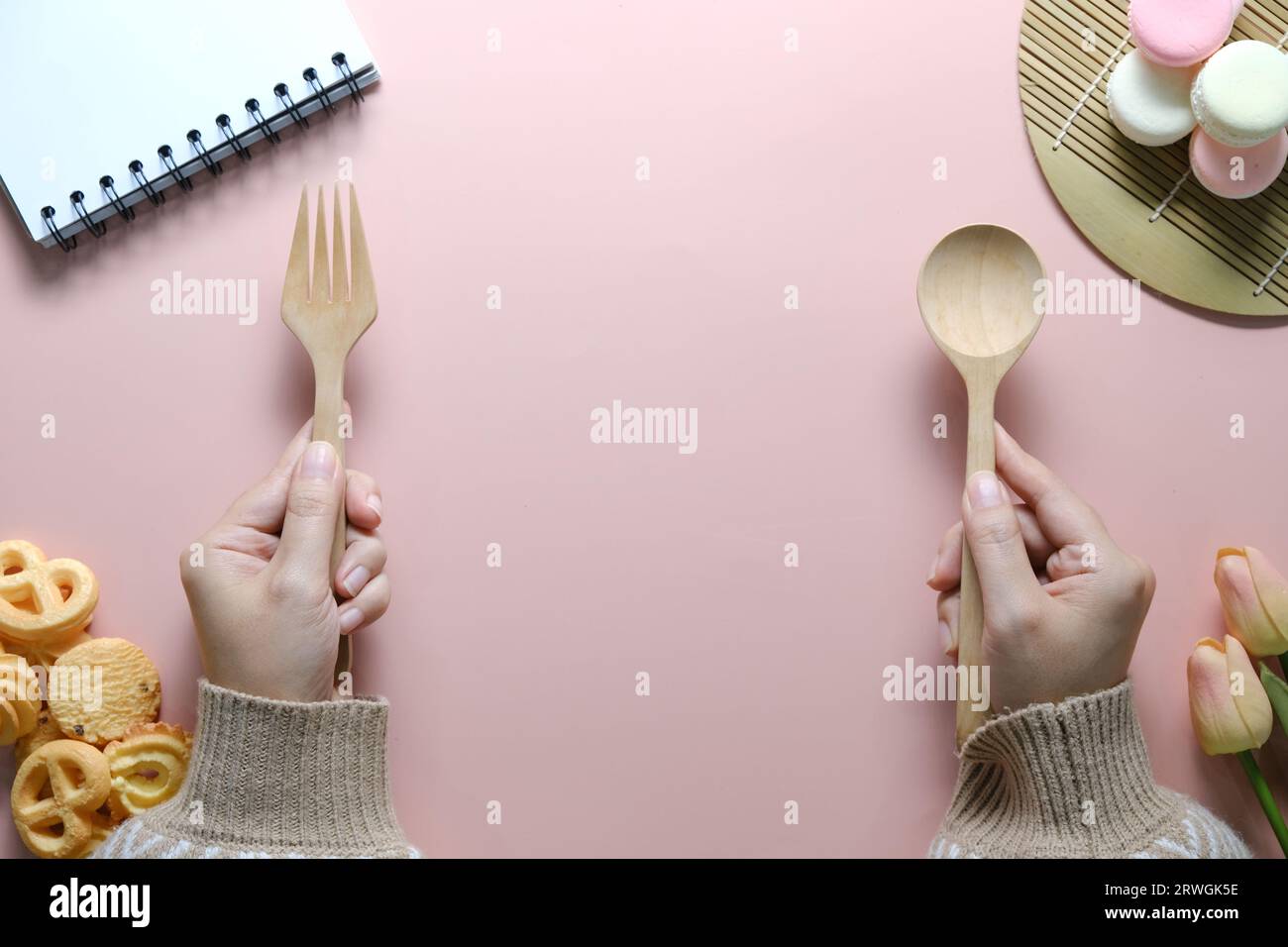 Top view of open spiral blank notebook on pink desk. Stock Photo