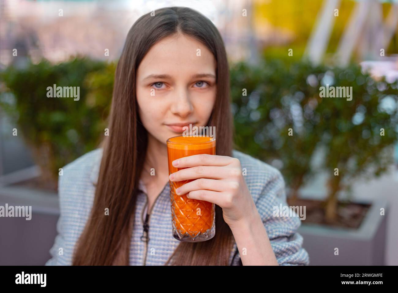 teen girl drink multivitamin fruit juice. fresh carrot and apple juice