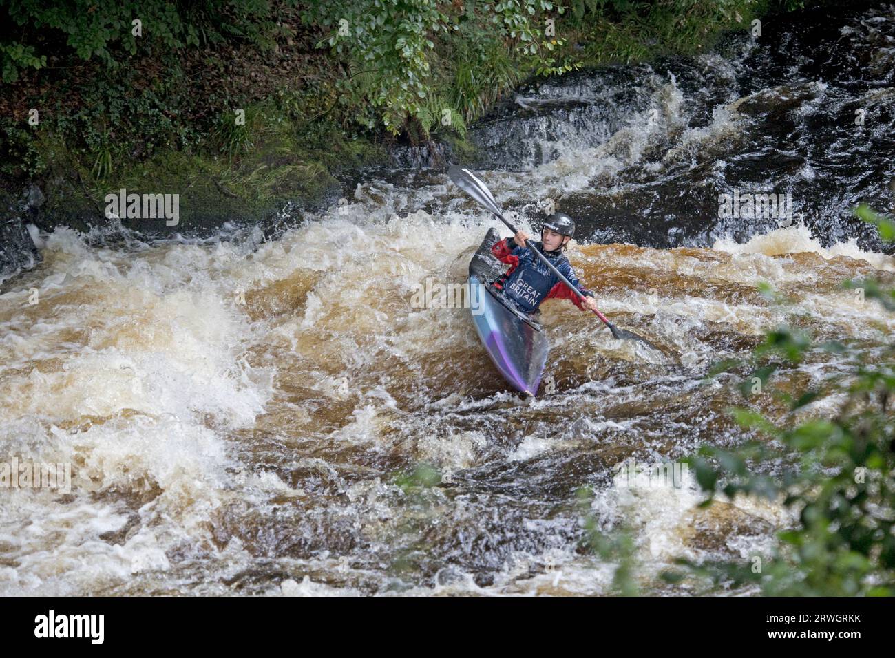 Canoeist in slalm canoen riding the in rapids Whitewater slalom canoeing  in River Tryweryn at the National Whitewater Centre near Bala North Wales Stock Photo