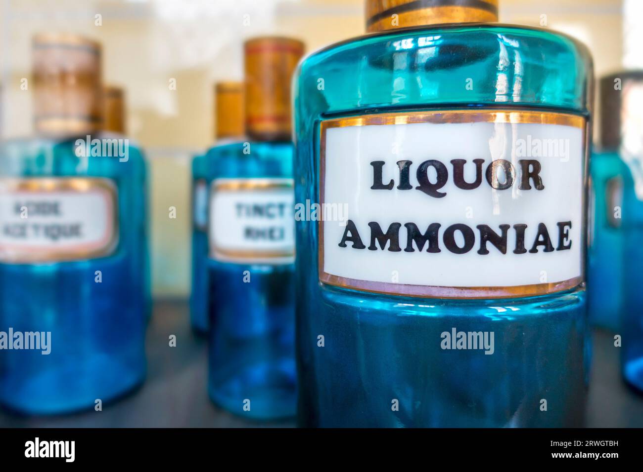 Antique apothecary blue glass jar / bottle with Liquor Ammoniae, also known as Ammoniacal Liquor in vintage pharmacy Stock Photo
