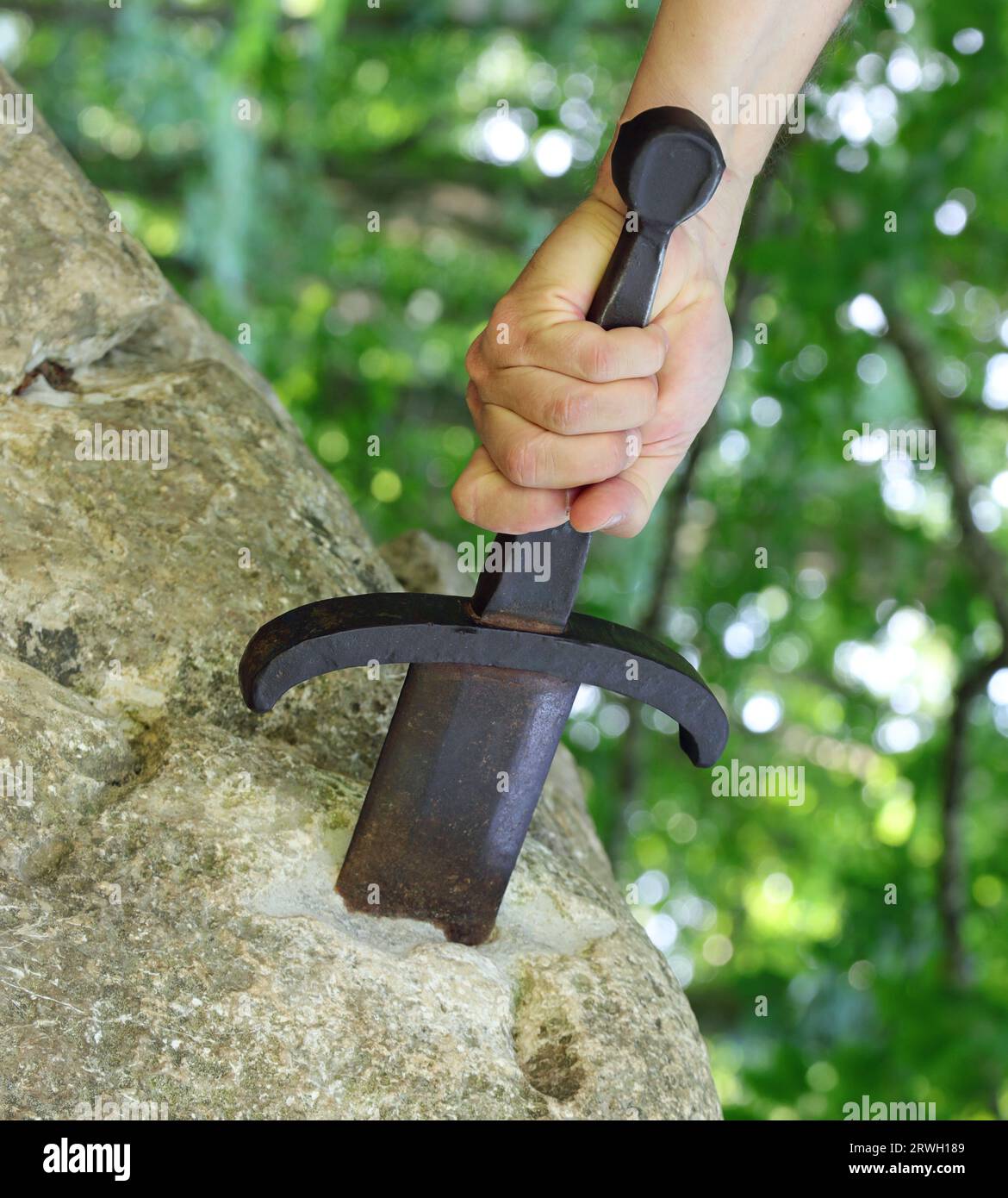 hand forcefully extracts the sword in the rock as in the mythological