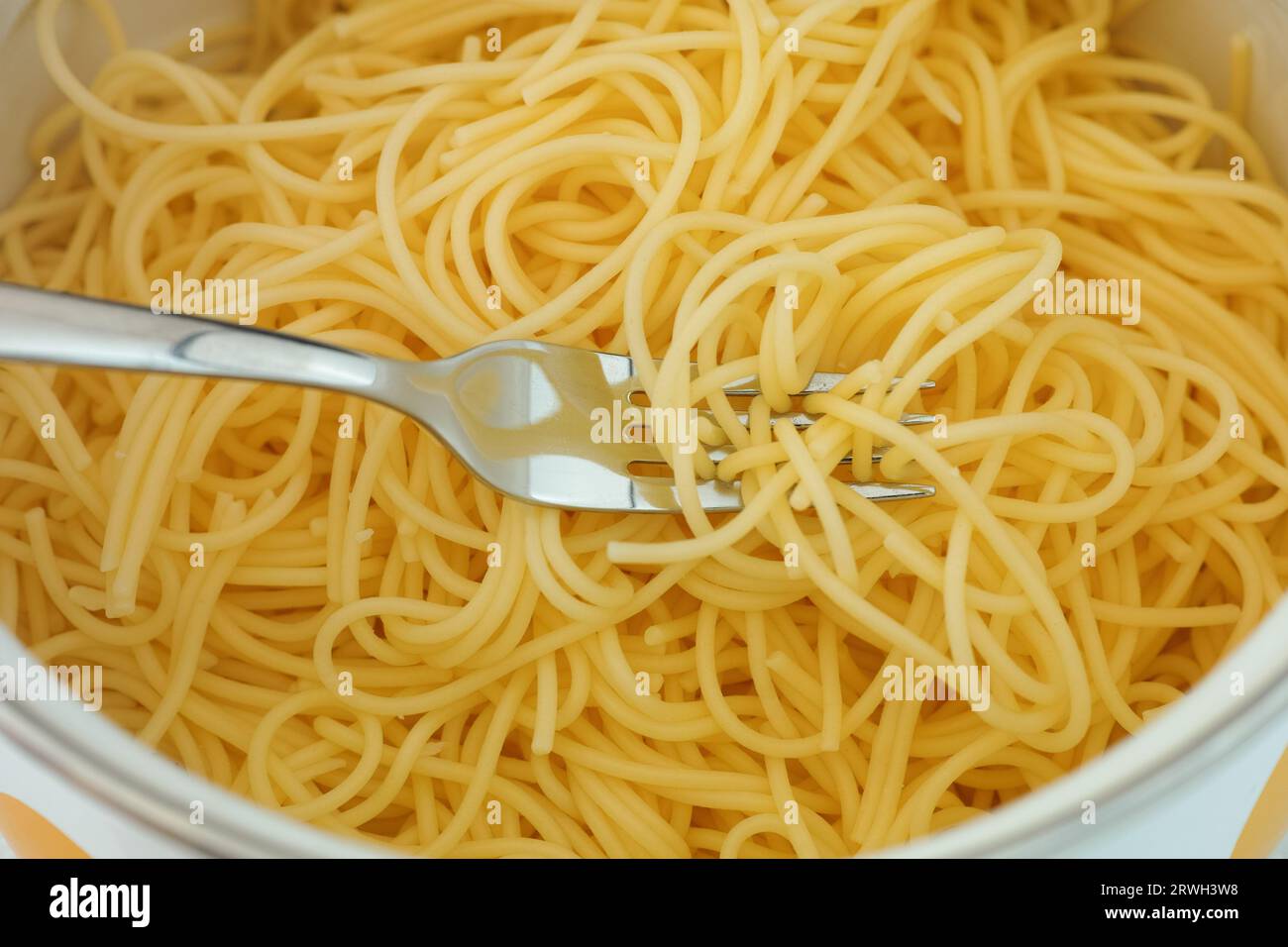 Gluten free spaghetti in a pot with a fork. Close up. Stock Photo