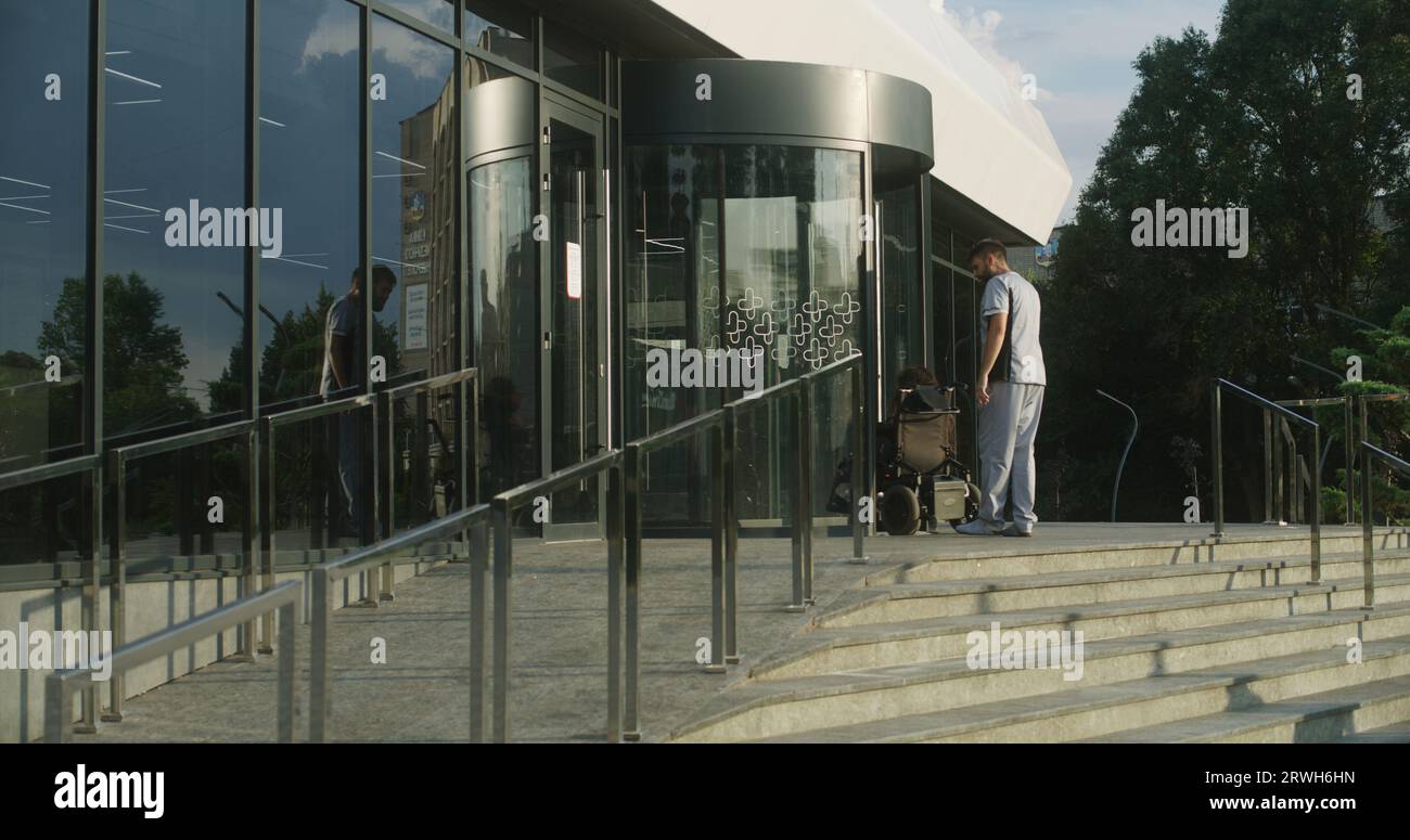 Woman with physical disability rides into clinic entrance on motorized