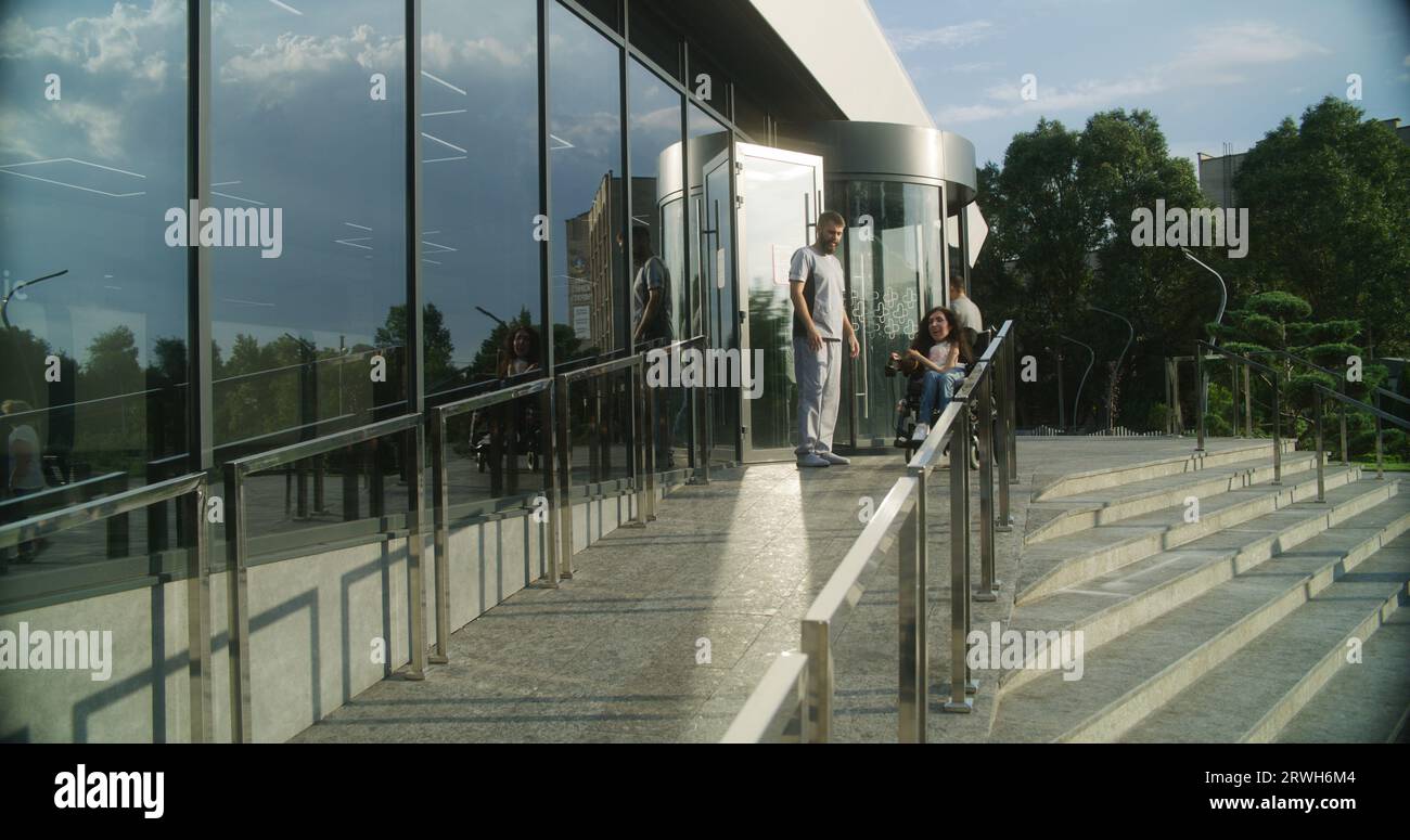 Woman with physical disability rides into clinic entrance on motorized