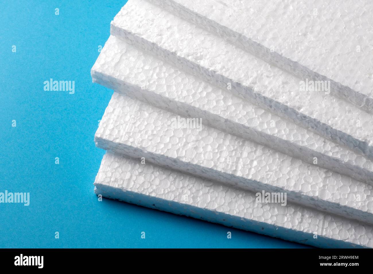 Styrofoam sheets on blue background Stock Photo
