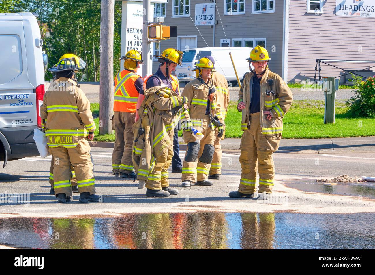 A group of firefighters relax after responding to an emergency call in Sydney Nova Scotia.. Stock Photo