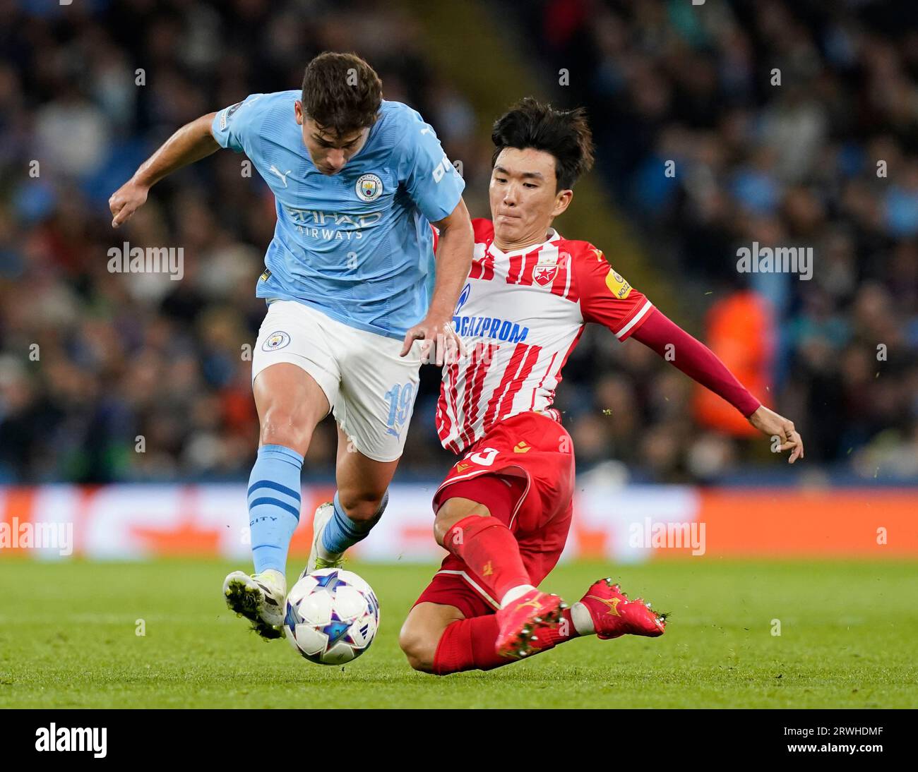MANCHESTER, UK. 19th Sep, 2023. Julian Alvarez of Manchester City tackled by Inbeom Hwang of Red Star Belgrade during the UEFA Champions League match at the Etihad Stadium, Manchester. Picture credit should read: Andrew Yates/Sportimage Credit: Sportimage Ltd/Alamy Live News Stock Photo